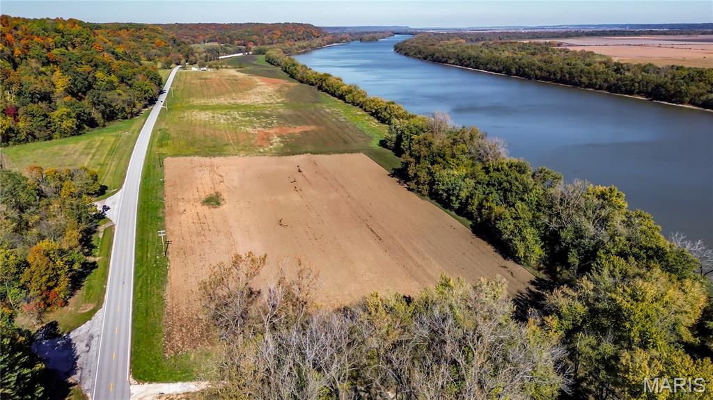 10 acre water front tract along the Illinois River offers many uses. Over 800 ft. of water front access with the opportunity to develop RV PARK, elevated cabins, campground, riverfront wedding venue. This area is known for hunting and fishing. Boat launch is located in Kampsville. Boat docks & campers are allowed! Bring your vision and come to Calhoun County! Utilities available along the property; tap on fees may apply.