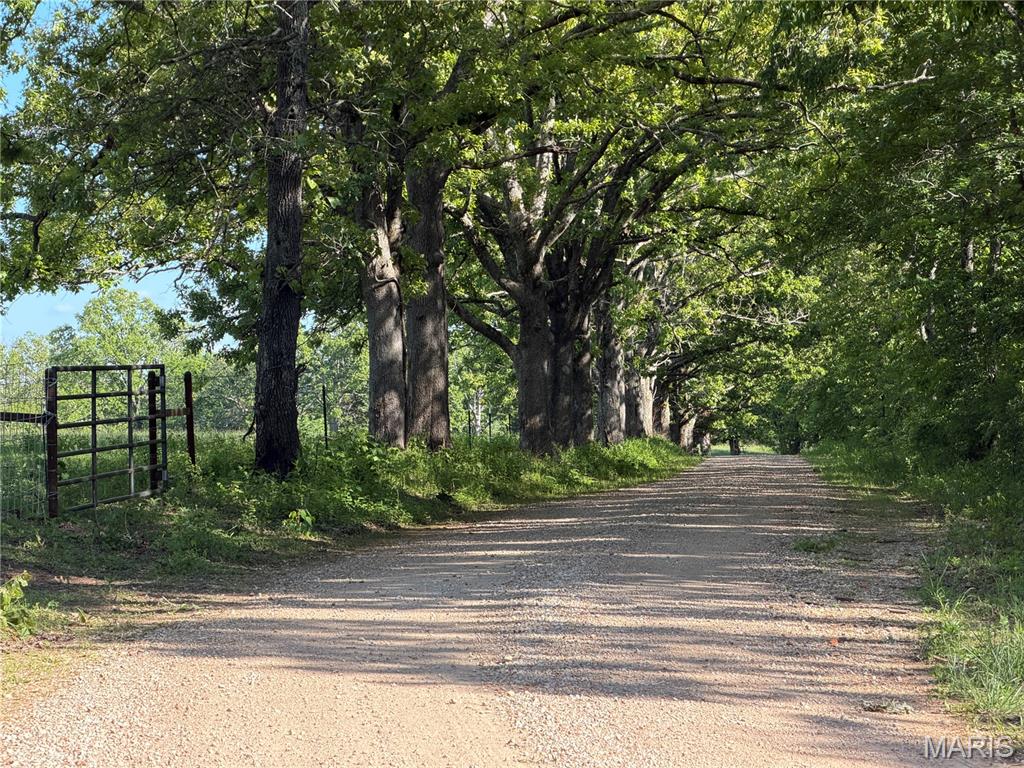 This property offers valuable timber with mature white oak, red oak, and hickory, plus winding trails through the woods and a seasonal creek along the north edge. There’s also a mix of pasture with partial fencing and woods that’s great for livestock. You’ll find several prime spots to build a home, each providing privacy and peaceful surroundings. Located on a well-kept gravel road just 0.3 miles from a chip-and-seal road, it’s easy to access year-round. Outdoor lovers will enjoy being minutes from Shawnee Mac Lakes and Mark Twain National Forest, and within half an hour of the Current and Meramec Rivers. Wildlife is abundant, with plenty of deer and turkey for hunters. A survey will be done before closing, and adjoining tracts are available if you want more acreage. Electric easement is in progress. Schedule your private showing today.  Tract 5 mls# 26029253 and Tract 7 mls# 26030317 added to this tract  would make a great 80 acres with access from the gravel road and the chip and seal road. Owner financing is an option with owners approval and down payment.