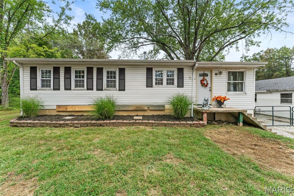 Charming 2-bedroom, 1-bath ranch-style farmhouse situated on a beautiful, level 1+ acre lot. This well-maintained home features original hardwood floors in the living room and bedrooms, an updated bathroom, newer kitchen appliances, and newer windows throughout the living room, kitchen, bathroom, and bedrooms. The spacious sunroom addition provides the perfect place to relax or entertain family and friends year-round. A full unfinished basement with a poured concrete foundation offers abundant storage and future expansion potential. Outside, you'll find an oversized 28' x 36' garage/shop, ideal for hobbies, projects, or extra vehicle storage. The large backyard also includes a 14' x 22' shed with a concrete floor and electricity. With no HOA and no restrictions, this property is perfect for those seeking space, flexibility, and the opportunity to create their own hobby farm or country retreat.
