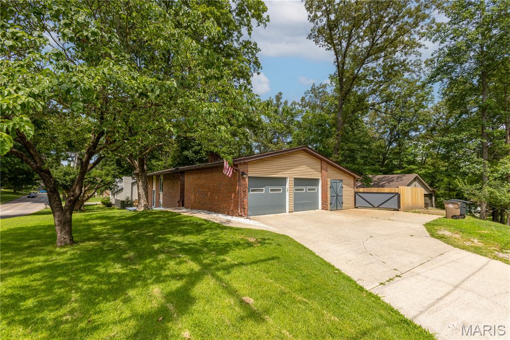 I AM GORGEOUS INSIDE!  Offering over 3,000 of living space in a convenient location with so many upgrades.  Come on inside and you will be amazed at the unique charm this home has to offer.  This open concept creates great family gathering space with custom built ins for charachter.  Updated kitchen Quartz counters, along with the gorgeous wood flooring makes this area a stand out.  Also located on this level 2 bedrooms, Laundry room, and garage entrance (no steps) , in addition to the garage a workshop, man cave is easily accessed from the laundry room.  Downstairs you will find 2 more bedrooms, Full Living room, and plenty of storage space.  Walk out to the backyard oasis patio, a brand new fence and plenty of room for the imagination.  This home is a rare find with so many updates.  Just to mention a few things this owner has updated:  Windows, kitchen counters, bathroom remodel (downstairs), installed fence, removed trees, replaced sewer line.  This family has loved this home and put in plenty of sweat equity to make it gorgeous and cozy, and now it is ready for a new family.  Refrigerator and Washer and Dryer to remain.  FYI:  Stove was electric and changed now to gas.   Fireplace was never used during ownership