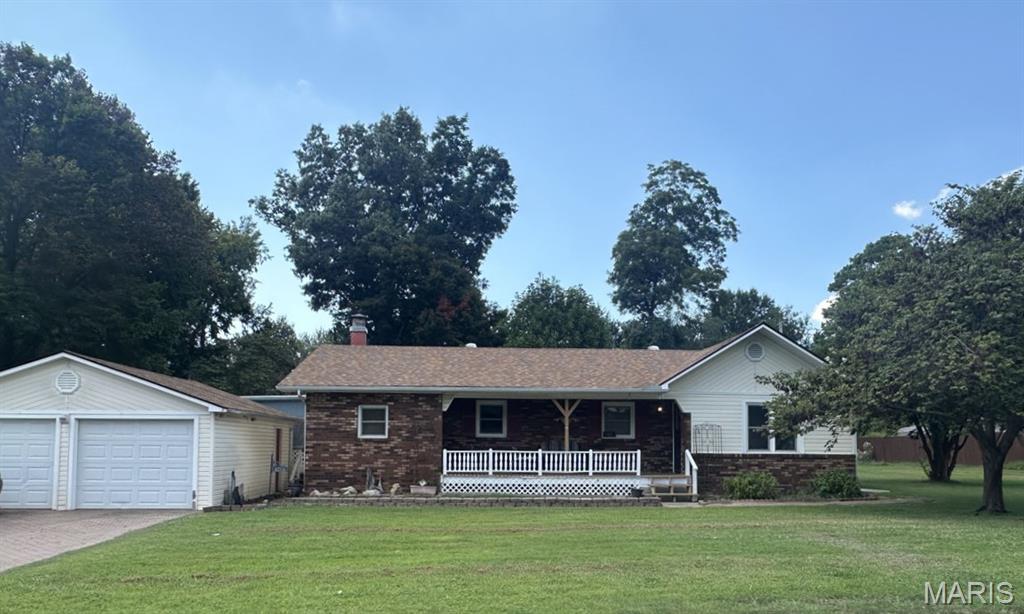 Welcome to this well-maintained ranch-style home, lovingly enjoyed by its longtime owners. Situated on a generous 133' x 150' lot, this 1,468 sq. ft. home offers 3 bedrooms, a full hall bath with tub/shower, formal dining room, living room with built-in display feature and closet, and a cozy family room with corner fireplace, hearth, and natural gas hookup. The kitchen features a snack bar, ceramic tile backsplash, refrigerator, dishwasher, and smooth-top electric range. Enjoy relaxing outdoors on the spacious 12' x 16' screened porch or covered 6' x 22' front porch. The fenced yard is pet-friendly and includes an 8' x 16' storage shed. A 22' x 26' detached two-car garage provides plenty of room for vehicles, storage, or shop work. A versatile property with space, comfort, and plenty of possibilities!