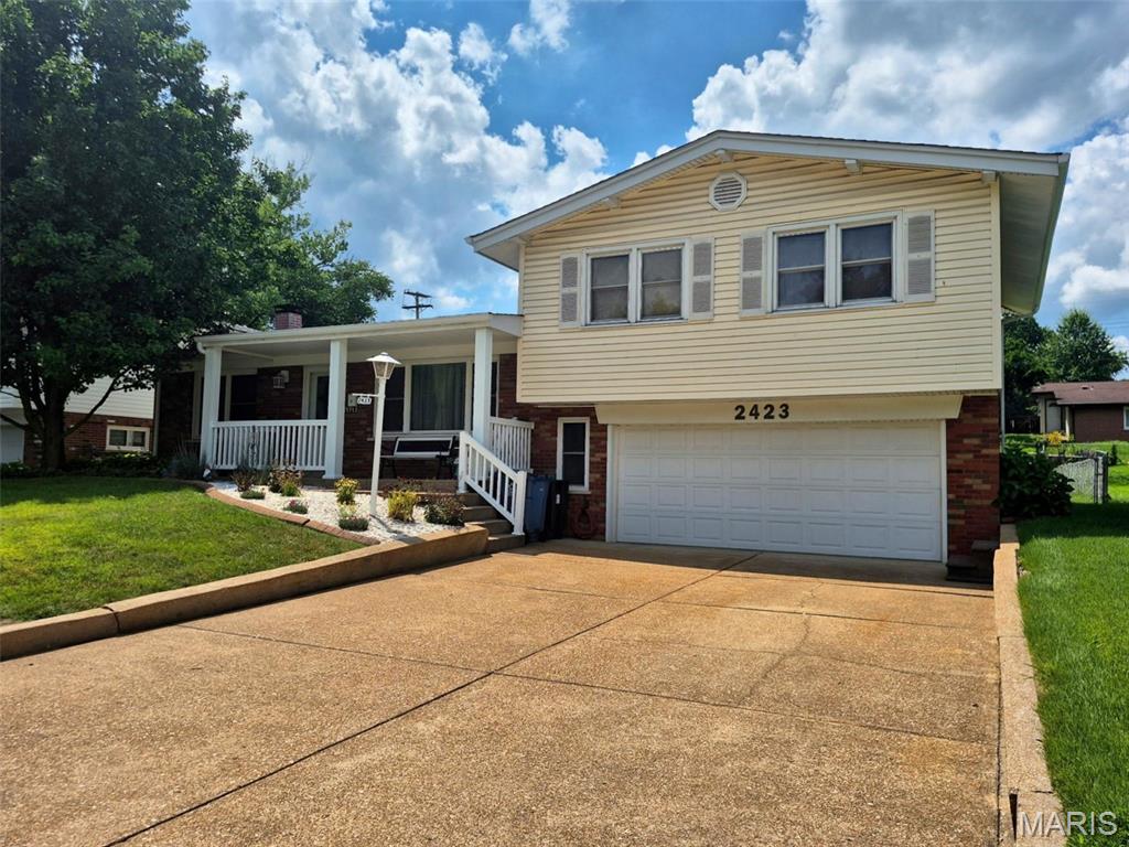 BACK ON MARKET ... NO FAULT OF SELLER ... Beautifully maintained multi-level home nestled in the heart of Overland, showcasing wonderful curb appeal, cozy front porch, an impressive 1,450 sq ft of living space, and a list of high-quality updates! Pride of ownership is evident throughout with numerous recent improvements, including a new architectural shingle roof with ridge vent, gutters, gutter guards, and downspouts (2024), Carrier high-efficiency furnace and A/C with humidifier (2021), HWH (2024), upgraded insulation throughout the exterior walls and attic (2021), French drain (2018), professional landscaping, and much more!  The welcoming, open floor plan offers spacious living and entertaining areas, including a bright living room, formal dining room, and an inviting family room highlighted by a stunning floor-to-ceiling brick wood-burning fireplace.  Stylish, updated kitchen is sure to impress with custom 42-inch wood cabinetry, crown molding, soft-close drawers, pull-out shelving, lazy susan, pantry, breakfast bar, built-in wall oven, electric cooktop, Bosch dishwasher, Samsung microwave, Moen faucet with sprayer, and recessed lighting. The adjoining breakfast room features sliding glass doors leading to the sunroom, where French doors open to the park-like level, fenced-in .22-acre lot with picture-perfect view from any angle—creating the perfect space to relax and enjoy the view year-round.  Upstairs, the spacious primary suite features hardwood flooring and an updated private bath with ceramic tile flooring, a marble surround shower, and a pedestal sink. Two additional bedrooms offer hardwood flooring, ceiling fans, and custom closet organizers.  Incredibly convenient location, fantastic oversized, insulated 2-car heated/cooled garage, plus main floor laundry!  Perfect combination of comfort, quality, and convenience, and it is ready for its next chapter.  Welcome Home!