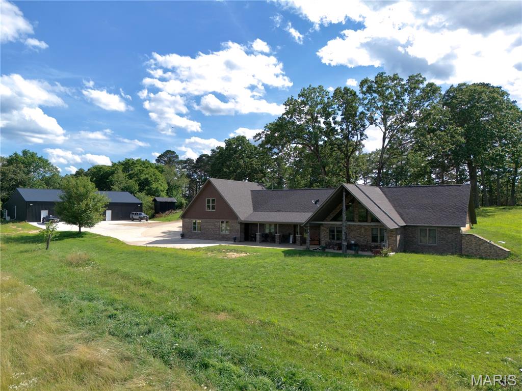 Custom 3 bed, 3.5 bath earth-home on 10 acres in Carter County, MO! Offering a beautiful setting with rolling pasture and distant timber views. The home features two living areas, a main-level primary suite with custom tile shower, plus an upstairs bedroom and full bath. Attached is an oversized 3-car garage provides ample workspace, with a large bonus room above. Beside the home is a brand-new 62x72 fully finished shop with heat/air, a bathroom, and a large bay door tall enough for a large tractor, excavator, and additional vehicles or equipment. A huge shop like this is also perfect for birthday parties, and other social gatherings. Just 10 minutes from a boat launch into CURRENT RIVER, 8 minutes to East Carter School in Ellsinore, and 35 minutes to Poplar Bluff. Homes of this caliber do not hit the market very often in this area, call today for a showing!