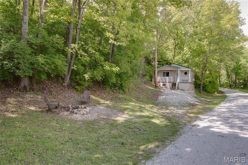 Nestled on 1.5 wooded acres, this turnkey studio cabin offers a rare blend of modern comfort, natural beauty, and income potential. Currently operating as a successful short term rental (Airbnb), the approximately 410 sq ft retreat features an open concept layout with luxury vinyl plank flooring, a full kitchen with quartz countertops, electric fireplace, and a full bath with laundry.

Thoughtfully designed and professionally styled, the cabin incorporates subtle nods to the area’s rich history, drawing inspiration from the Bredina Springs Quarry, White Hall Stoneware Company, and Indian Hillview pottery. Guests and owners alike enjoy a covered front porch overlooking the wooded setting.

Whether you’re looking for a weekend getaway, investment property, Airbnb, hunting cabin, this unique property offers endless possibilities. Conveniently located while still feeling secluded, Hillview House is a rare opportunity ready for its next owner.


Property Highlights:
• Approx. 410 sq ft studio cabin
• 1.5 wooded acres
• Covered front porch
• Full kitchen 
• Electric fireplace
• Luxury vinyl plank flooring
Agent owned