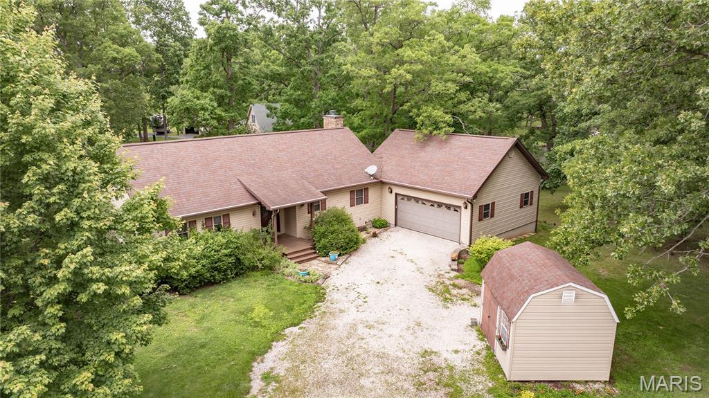 Discover the perfect retreat at 12749 Soaring Eagle on Lake Catatoga, a 66 acre lake located in Macoupin County.  This beautifully maintained 3-bedroom, 2 1/2 bath home features a huge primary suite with walk-in closet, double vanity, and walk-in shower, kitchen has granite countertops, sunroom, walk out basement, new Trek deck with beautiful views of the lake, wood burning fireplace in the lower level and electric fireplace on main level.  Large laundry room on main level.  All appliance stay including the washer & dryer.  Attached 2-car garage and a storage shed with electric.  2 x 6 construction.  Don't miss out-this is a Must See!!