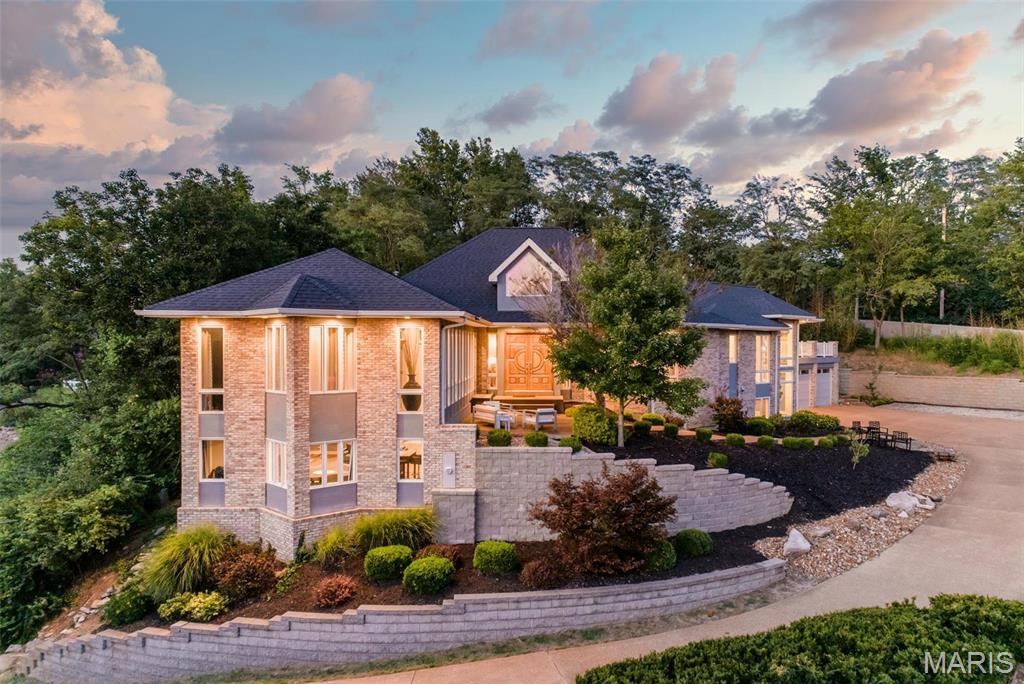 THIS UNIQUELY MODERN HOME OVERLOOKS A QUIET NEIGHBORHOOD OF CUSTOM HOMES. ENTER THE HARDWOOD GREAT ROOM THROUGH SOLID MAHOGANY DOORS TO SOARING WOOD CEILINGS.  ENJOY THE WET BAR AND FIREPLACE WHILE VIEWING THE PRIVATE POOL/HOT TUB. A SPLIT FLOORPLAN PROVIDES A PRIVATE MAIN BEDROOM OASIS WITH POOL VIEW, HEATED BATHROOM FLOORS AND A POCKET DOOR CONNECTING THE WALK-IN CLOSET WITH LAUNDRY ROOM. GLASS HALLWAY LEADS TO THREE BEDROOMS WITH TWO FULL BATHROOMS. EXTENDED FAMILY AND FRIENDS CAN GATHER IN A HUGE KITCHEN WITH EAT-AT BAR, BUTLER'S PANTRY, BOSCH APPLIANCES, AND A DOUBLE OVEN. THE "PARTY DECK" OFFERS AN OUTDOOR KITCHEN OVERLOOKING THE LARGE CUSTOM GUNITE POOL.  THE ABOVE GRADE BASEMENT PROVIDES TWO LARGE LIVING SPACES AS WELL AS A FINISHED WORKSHOP.  LOTS OF SMART HOME FEATURES ARE INCLUDED AS WELL AS AN 8X12' SHED FOR POOL AND YARD EQUIPMENT. FINISH WITH A 3 CAR GARAGE WITH EPOXY FLOORS AND SLAT WALLS, WITH A 220 OUTLET FOR AN EV. NEWER HVAC SYSTEMS, APPLIANCES, ROOF, WATER HEATERS, WHOLE HOUSE GENERATOR.