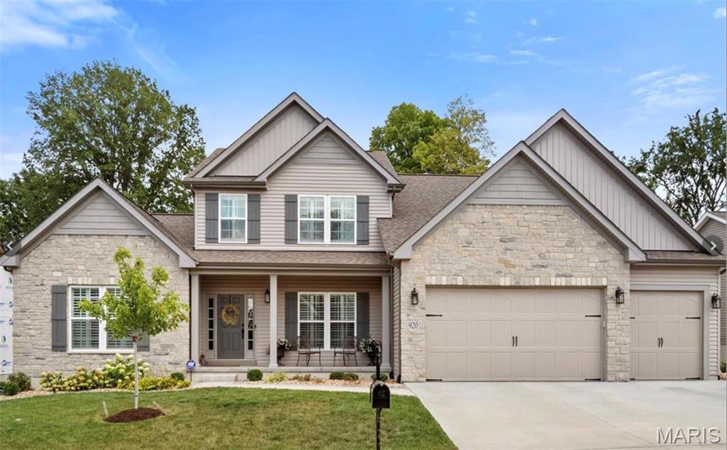 Wake up inspired. Entertain effortlessly. Unwind beautifully. Sunrise to sunset, this charming residence simply delights. From its handsome brick-and-stone elevation to its well-designed, light-filled spaces, casual elegance abounds. Love an open floor plan? This one boasts 9' ceilings & wide-plank engineered hardwoods that lead you room to room. Open view from the foyer into the dining room, complete with a designer accent wall and wow-worthy custom chandelier. Revel at both the formal living & hearth rooms that have fireplaces and unique feature walls that warm the open space, leaving it livable yet crisp. Talk it up, prepping meals with friends and family in a well-equipped kitchen that sits center stage with a large island. It boasts beautiful white cabinetry, sleek marble counters, custom lighting. A gracious primary suite offers respite from your busy day, dressed with hardwoods, plantation shutters, a walk-in closet, and a luxury bath with a custom-tiled shower, a garden soaking tub, and dual vanities. Upstairs, three nicely-sized additional bedrooms with loads of closets, two baths and a comfy loft await. The lower level features a utility/game/workout space with LVP flooring, a full bathroom, the 5th bedroom and carpeted open living space. And, while the interiors certainly beckon you to put your feet up, soon the outdoors will be be calling your name. Marvel at nature’s beauty, dine alfresco, or look up and count your lucky stars. Go ahead, pinch yourself. This is the life!