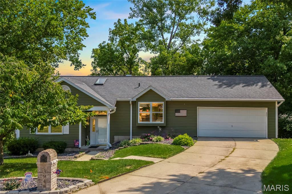 Updated home located in the popular subdivision of the Vineyards in St Charles! This home boasts 3 bedrooms, 3 bathrooms, and 2000+ square feet of living space including the finished, walkout lower level.

The front door opens to the bright & airy living room with a gas fireplace, bay window, and gleaming hardwood floors that flow throughout most of the main level. The updated kitchen boasts black stainless steel appliances, newer cabinetry, newer countertops, newer sink, multiple skylights, and opens to the formal dining area with multiple bay windows.

The primary bedroom features a vaulted ceiling, bay window, and a luxurious bathroom. An additional bedroom and a full hall bathroom complete the main level.

The finished lower level boasts a recreation room, 3rd bedroom, full bathroom, and ample storage space with a utility sink. Other highlights include: 2 car attached garage, additional insulation added (2024), new solar attic fan (2024), new retaining wall in backyard (2022), newer light fixtures throughout most of the home, improved landscaping, new HVAC (2023), newer water heater (2019), and painted neutral colors throughout.

Relax outside on the newer vinyl deck (2016) or on the newer concrete patio (2017) & enjoy the private wooded backyard! Subdivision amenities include a pool, clubhouse, tennis courts, and exercise area.

Location could not be better – close to shops, restaurants, schools and major highways!