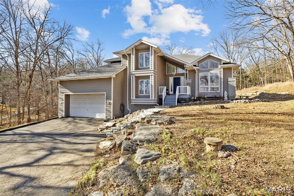 Nestled on a private 3-acre wooded lot, this home offers the perfect blend of space, privacy, convenience, and charm-opportunities like this are rare!  Step into the foyer and formal living room featuring a cathedral ceiling with beautiful wooden beams.  This home offers generous living space including:  4 bedrooms, 3 bathrooms, a finished basement, a large kitchen with an island, a NEW ROOF, NEW SEPTIC, and much much more!  Windows throughout the home provide plenty of natural light and allow you enjoy the serene views of the property.  Schedule your showing today-you won't want to miss out on this incredible opportunity!
