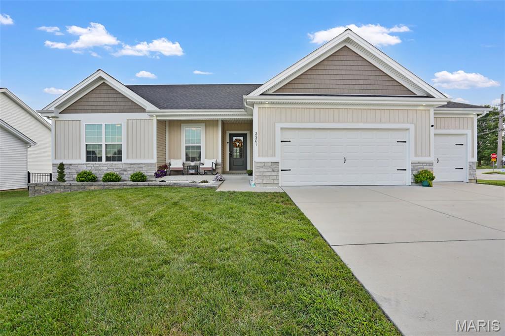 Welcome to this beautiful 3BR/3BA home with over 2400 sq ft of living space!  Built in 2024, this ranch home is loaded with builder upgrades as well as personal ones!  Step inside and enjoy the open concept living area with 9ft ceilings , a cozy fireplace in the great room and luxury vinyl plank flooring throughout.  Large windows make the main living space light and airy leading to a custom kitchen with a huge center island, stainless steel appliances and granite countertops.  Step from the separate dining room to your outside maintenance free deck with great sunsets and view of the outdoor firepit.  The spacious primary suite has large walk in closet and private bath with dbl bowl vanity and shower.  Main floor laundry provides convenience with extra cabinetry for storage.  Walk out lower level features great entertaining space with  additional bath and family room with a dry bar.  Extended 3 car garage  with cabinets is a major plus for all lawn equipment and the "toys"!  New landscaping all the way around with new retaining wall in front of home.  Tons of upgrades were put into this home when building, including extra canned lighting, superior siding, additional windows, brick accents and soffit lighting.  This move in ready home is located in a newer community,  close to all of the amenities Washington has to offer along with a great place to raise a family or simply retire!  Come take a tour today!!