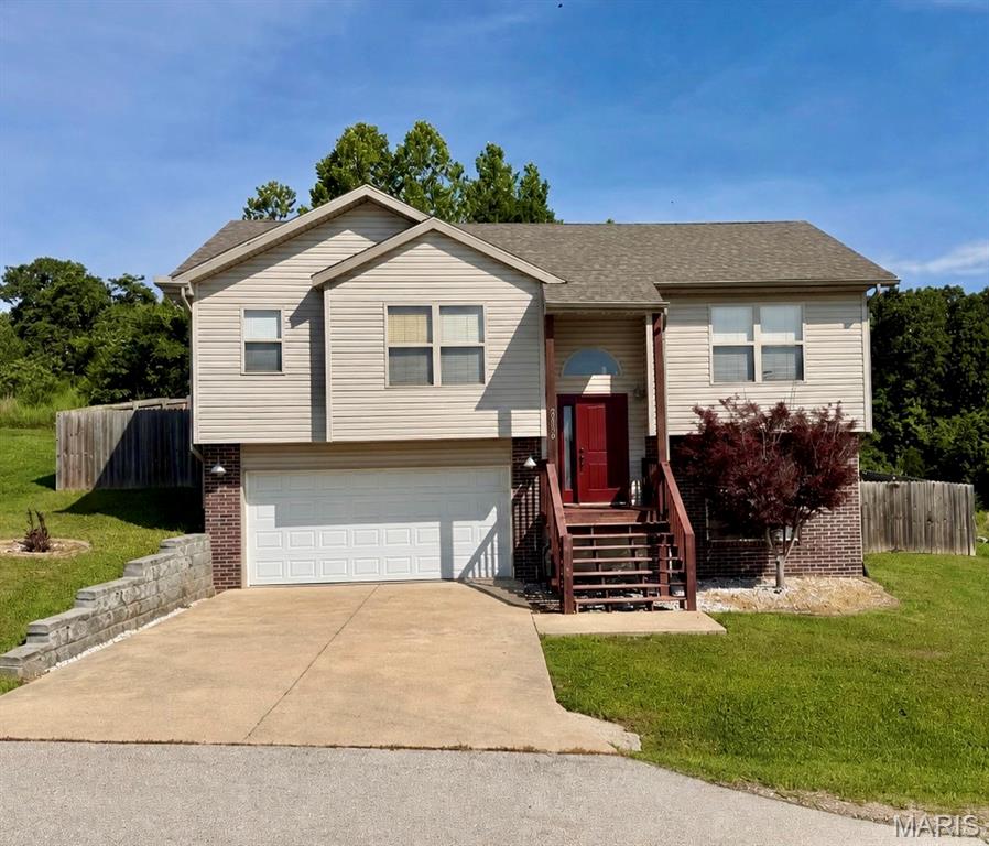 Welcome to 20239 Havana Lane in St. Robert! This 3-bedroom, 3-bath home offers a functional layout with two bedrooms on the main level and an additional bedroom, bathroom, and spacious family room on the lower level. Wood flooring highlights the main living area, while the primary suite features a walk-in closet and private bath with dual vanities, a soaking tub, and separate shower. Enjoy the privacy-fenced backyard and a small rear deck, perfect for relaxing or entertaining. Built in 2011, this home also features a 2-car garage and is situated on a low-traffic street in the Waynesville School District. Conveniently located just minutes from St. Robert amenities and Fort Leonard Wood. Square footage is approximate; buyer to verify all measurements and information.