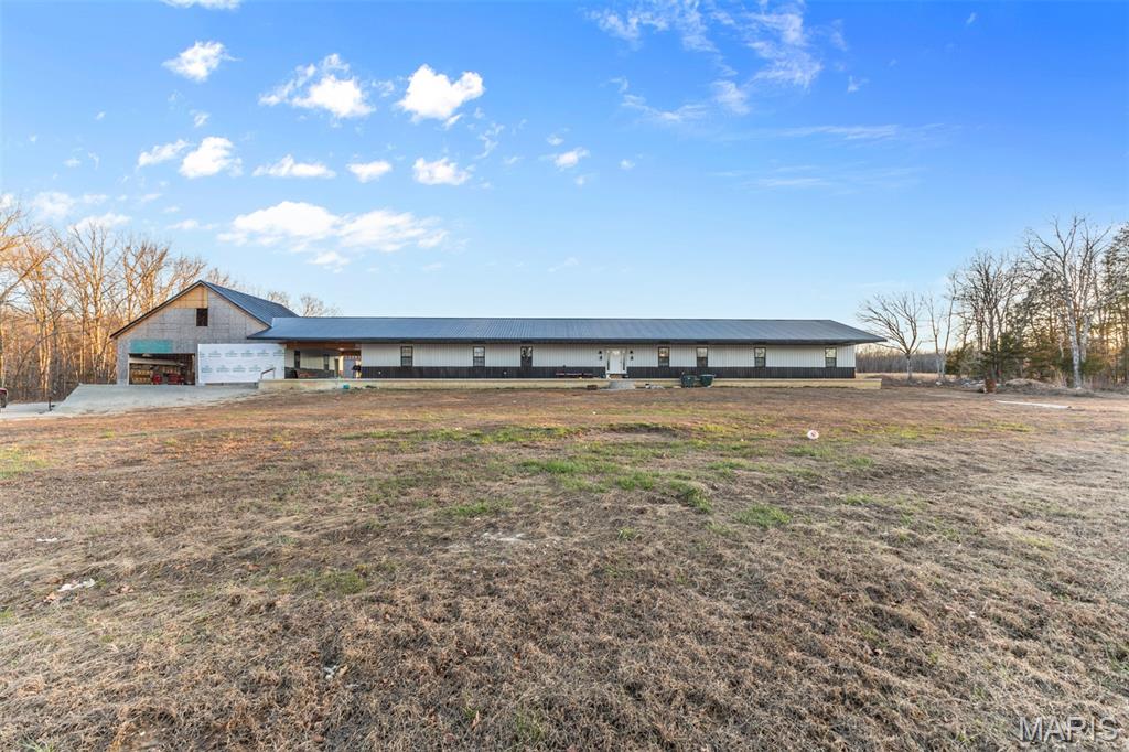 A rare opportunity to own a newer, custom built 10 bedroom 6.5 bath estate nestled on 62 m/l  breathtaking private acres. Designed for both grand-scale entertaining and comfortable everyday living, this expansive home offers generous living spaces, abundant natural light and exceptional privacy. The surrounding acreage invites outdoor adventures, gardening, equestrian use, farming, or simply enjoying peaceful country living. Ideal for a large or multi-generational family seeking space, serenity, and refined comfort.