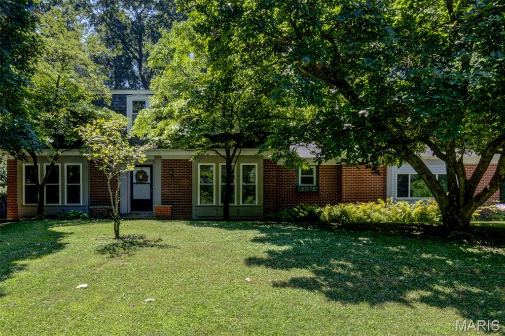 Nestled on a breathtaking 1.314-acre million-dollar lot, this private wooded estate offers an extraordinary blend of nature, serenity, and convenience. Wake each day inspired by God's magnificent creation, with picturesque views in every direction and abundant wildlife right outside your door. A welcoming brick patio and long private driveway create a memorable arrival, while the peaceful setting feels worlds away—yet you're just minutes from major roads, highways, shopping and restaurants. The subdivision pool & playground are conveniently located just across the street. This spacious two-story home offers 2,444 sq. ft. above grade with 5 bedrooms, including a main-level bedroom and 3 full baths. Designed for flexibility, the home features two primary suites—one on the main level and another upstairs—each with an adjoining full bath, making it ideal for multigenerational living, guests, or a private home office. Built for lasting value, the exterior showcases low-maintenance brick on three sides with vinyl siding, an oversized side-entry garage, updated garage door plus roof and gutters (2017), thermal windows, upgraded sliding patio door and a 2024 electrical panel. Inside, you'll find beautiful wood floors, skylights, neutral decor, a cozy wood-burning fireplace, white six-panel doors, central vacuum, attic fan, security system, generous closet space, select bath updates  plus added attic insulation and ridge guard on roof for improved efficiency. This is a rare opportunity to own an exceptional property where natural beauty and everyday comfort come together in high-rated Parkway Central School Distrct. Home located in the 100 year flood plain. Flood insurance required for loan.