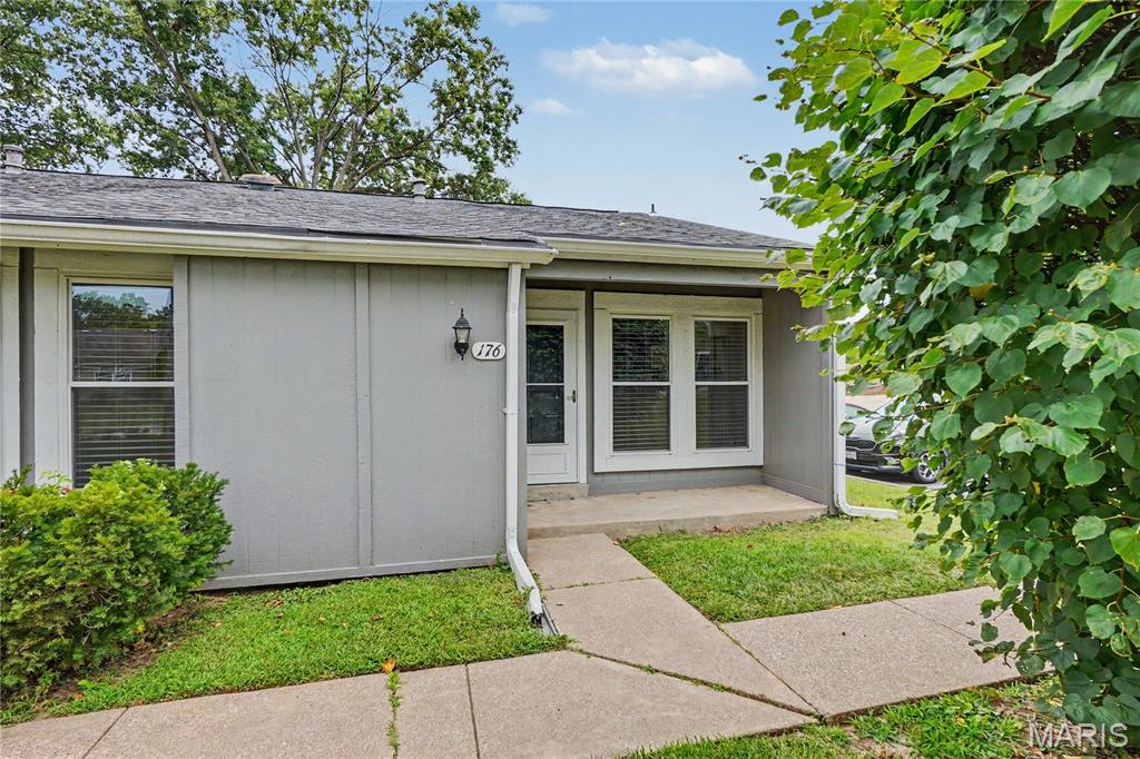 OPEN HOUSE 1-3PM SATURDAY 9/12/26!  Located in a lakeside community with lots of amenities, this spacious single level living villa-condo has plenty of character as your new home. Covered front porch greets you at entry into the soaring vaulted ceilings at entry foyer, kitchen and living room with natural wood beams.  Beautiful natural light flows throughout! Homeowner has taken the time for the you to movie-right-in:  new flooring, fresh paint, double pane, argon gas windows and sliding glass door with a lifetime warranty...and a wood burning fireplace!  Convenient back patio off living room with nice storage shed to boot! Main level laundry with stackable unit that stays. Enjoy all the amenities that Lake St. Louis has to offer with over numerous clubs, beach access not only privately for Harbor Town residents, but also LSL Community pools, golf, clubhouse, pickleball, tennis, and so much more.  Property is also less than 5 minutes from Founders Park Sports Complex.  You'll also enjoy the very close assigned parking spot with convenient additional parking for guests. Stop by today!
