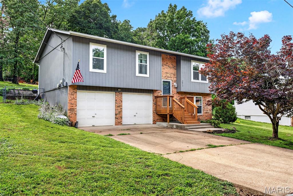 Welcome to this spacious 4-bedroom, 3 full-bath home in the heart of High Ridge! Offering amazing living spaces and a functional layout, this home features 3 bedrooms and 2 full baths on the main level, including a private primary suite. The main floor showcases beautiful hardwood flooring throughout the living room, dining room, kitchen, and hallway. Just off the dining area, you'll find a covered patio overlooking the backyard—perfect for relaxing or entertaining guests. Situated on just under half an acre, the large fenced backyard provides plenty of space for pets, gardening, or outdoor gatherings. The finished lower level includes a generously sized fourth bedroom with a large closet, a full bathroom, and a utility room with washer and dryer hookups, offering flexibility for guests, a home office, or additional living space. Additional features include a spacious 2-car garage, new energy efficient double hung windows and a roof that is only 2 years old, providing peace of mind for years to come. Don't miss this incredible opportunity to own a well-maintained home with plenty of space both inside and out!