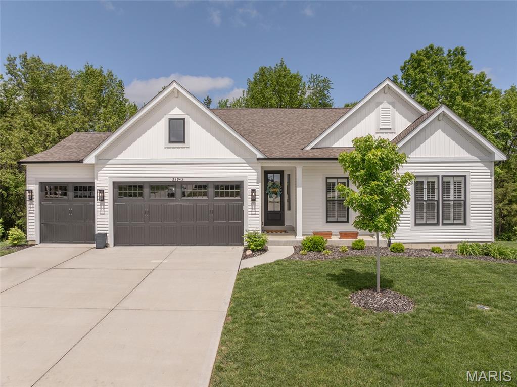 Dramatic Price Reduction! Compare to what it would cost for new with a finished lower & a screened in porch and save big $$$ It is not often you get the opportunity to own one of the best lots in the subdivision! This fabulous wooded homesite backs to trees and more trees!  3-year-new home is absolutely stunning! There is so much to love about this awesome 1900 square foot home plus a professionally finished walk-out lower level that adds an additional 800 sq ft. Now add another 210 sq ft of living space in the great outdoors on the professionally built 15x14 screened in porch with vaulted wood ceilings and low-maintenance construction. There are so many upgrades & extras to love - floor to ceiling stacked gas fireplace surrounded by built-in bookshelves & Luxury Vinyl Plank Flooring through out the entire house are just a couple of our favorites. Chef-style kitchen with beautiful soft close cabinets with glass door accents, cabinet crown molding, Quartz countertops, under cabinet lighting, island with a breakfast bar, upgraded appliances, 9 foot ceilings & an adjoining spacious breakfast room that walks out to the fabulous screened porch! This spacious plan shows off it's size with a dramatic 11 foot foyer, expanded walk-in pantry, large laundry room and a niche for a desk - so special! The vaulted great room gives you exceptional nature views, fabulous fireplace & a desk area. A spacious private primary bedroom has amazing coffered ceilings and an upgraded luxury owner's bath with vaulted ceilings, separate tub and shower, double vanity and large 8x6 walk-in. On the front of the house are two additional bedrooms, and a full bath. After touring the guest/kids rooms head downstairs to see the recently professionally finished lower level. The walk-out basement has a large feature window to let the outside in to the giant rec/family room complete with a wet bar area with quartz counters & a wine cooler. Open to this room is an exercise area that would also make a great play area! Don't miss the 4th bedroom/private home office with walk-in closet. You still have tons of storage in this spacious floor plan! Other upgrades at time of construction are: Five Panel Doors; Matte Black Door & Cabinet Hardware; 4 1/2 inch Baseboards; Stunning 8 Ft Farmhouse Front Door & 30 Year Architectural Shingles. Extras that were added after construction include a Water Softener System, Custom Plantation Shutters, a Radon Mitigation System, Gutter Covers & Custom Floating Shelves. Everything about this home is "Just Right".  Road construction is making things a little inconvenient now but once the highway expansion is complete housing prices are sure to go up!