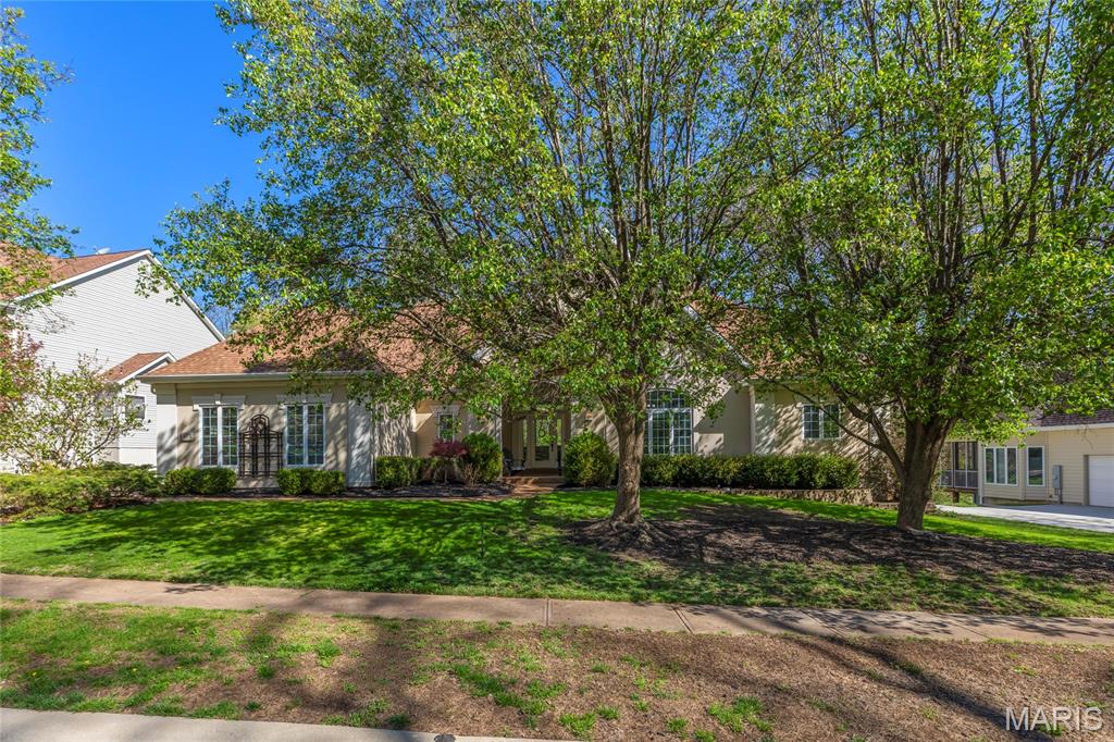 Stunning ranch-style home sitting on a 0.4 acre lot backing to woods, located in the sought after Polo Lakes subdivision in Ellisville! This home boasts over 4,000 square feet of living space, 4 bedrooms, and 3.5 bathrooms.

The front door opens to the entry foyer with a coat closet, columns, and gleaming hardwood floors that flow throughout most of the main level. The entry foyer opens to the office with crown molding and a new, custom bookcase (2025). 

The bright & airy great room features a wall of windows, gas fireplace, built-in bookshelves, vaulted ceiling and opens to the kitchen and formal dining room with crown molding, columns, and a bay window.

The kitchen boasts granite countertops, 42 inch cabinetry with crown molding, stainless steel appliances, new Bosch dishwasher (2025), new Lg microwave (2025), double ovens, refrigerator which is included, tile backsplash, butterfly island, dining area, planning desk, wine fridge, pantry with new custom shelving (2025), and sliding glass doors to the 3 seasons room. 

The primary bedroom features crown molding, a see-through gas fireplace, plantation shutters, a huge freshly painted (2026) walk-in closet, and a luxurious bathroom. The primary bathroom boasts tile floors, a dual vanity, soaking tub, separate shower, the see through fireplace, water closet, and linen closet. The powder room and laundry room with a utility sink complete the main floor. 

The lower level features a kitchen area, huge recreation room, three bedrooms, two full hall bathrooms, and ample storage space. Other highlights include: 3 car garage with built in shelving, zoned HVAC, electric pet fence, and 10 + foot ceilings. 

Relax in the 3 seasons room, on the composite back deck, or on the concrete back patio and enjoy the wild life in the yard backing to woods! The hot tub on the back deck is included. Location could not be better – close to major highways, restaurants, shops, schools, and Bluebird Park! Part of the award-winning Rockwood School District!