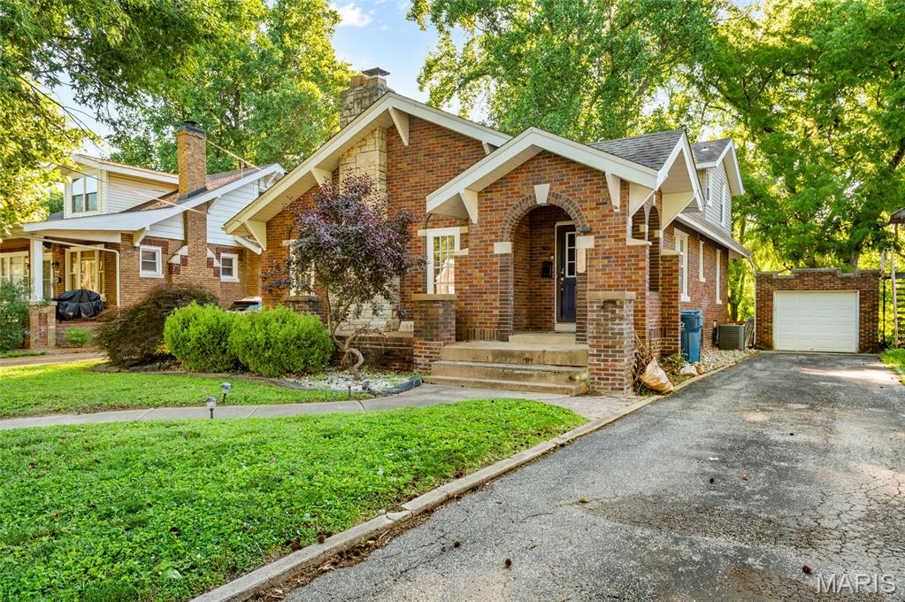 Welcome to this fully bricked 1.5 story home! This 4-bedroom, 2-bath home is filled with character and charm. The covered front porch instantly welcomes you. Upon entering there is a foyer with a convenient coat closet. This inviting living room showcases a cozy gas fireplace, hardwood flooring, and two arched doorways that add to the home's classic appeal. Hardwood flooring continues throughout the living room, dining room, and bedrooms. The separate dining room provides the perfect space for entertaining, while the kitchen is equipped with stainless steel appliances. Two bedrooms and a full bath complete the main level. Upstairs, you'll find two additional bedrooms and a second full bath. The full unfinished basement offers abundant storage space and can be set up with endless possibilities. Outside you can enjoy your morning coffee from the deck that overlooks the tree-lined yard. This outdoor space also includes a patio area, and a 1-car detached garage. From the charming architecture to the hardwood floors and the outdoor living spaces, this home offers the perfect blend of character, comfort, space, and functionality. This home is being sold AS-IS but has already passed city occupancy so it's ready for its new owner.  Call and schedule your appointment today! Buyers and buyer's agent to verify all data. Some photos have been virtually staged.