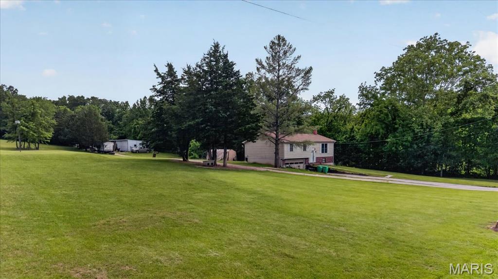 Nestled on 15 picturesque acres, this former horse property offers endless potential for those seeking country living, a hobby farm, or an investment opportunity. The property features a 3-bedroom, 2.5-bath home with spacious living areas and a peaceful rural setting surrounded by open pasture and mature trees. Previously set up for horses, the acreage provides room for barns, fencing, riding areas, or future agricultural use. Whether you're looking to restore its equestrian charm or create your own private retreat, this property is full of possibilities. Home is being sold in as-is condition.