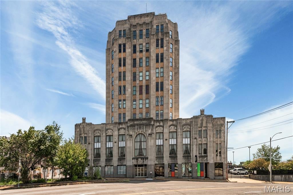Welcome to the iconic South Side Bank Building, located at the crossroads of the world in Tower Grove South. This bright corner unit offers an open floor plan, 9 foot ceilings, modern kitchen with a built-in herb garden, two spacious bedrooms, and in-unit laundry.
Step out onto your own mini rooftop deck, perfect for enjoying a little fresh air, taking in the views, or screaming down to the masses, “I growed up here!” (IYKYK)
Enjoy stunning city views from the shared rooftop patio, with a front-row seat to the 4th of July fireworks. Accessibility features include a building entrance ramp and elevator access. Building amenities also include gated parking with two spaces, secure entry, basement storage, and water, sewer, trash, lawn care, and snow removal.