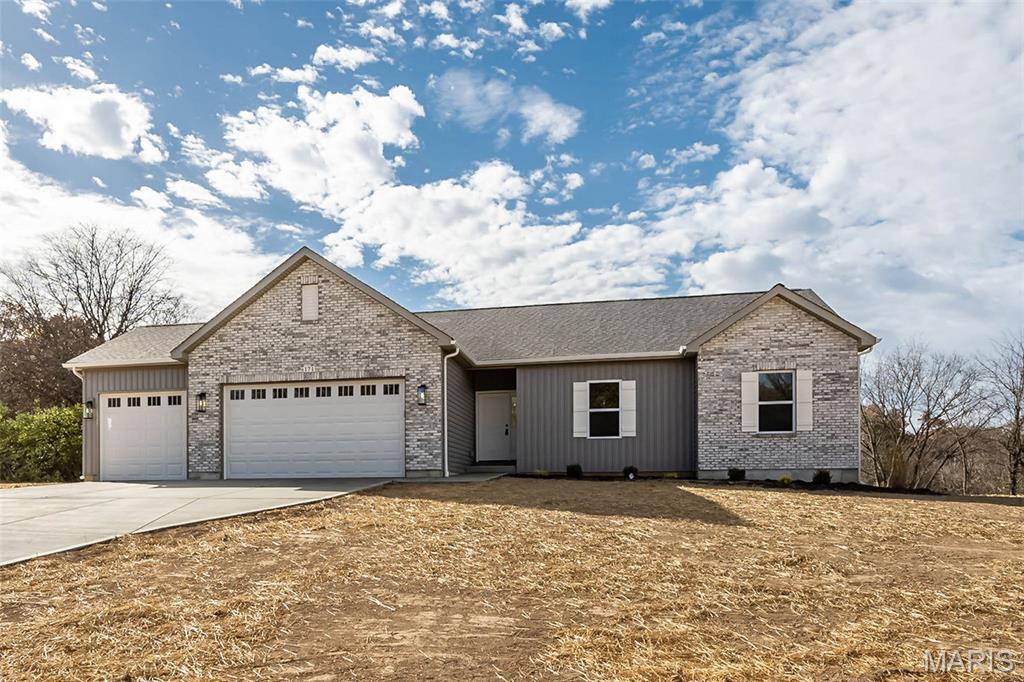 Nearly 6 Acres, a Flat Private Backyard, Stunning Custom Kitchen & Oversized 3-Car Garage—this display home combines exceptional upgrades with a hard-to-find acreage setting. The level, private backyard offers incredible flexibility for a future pool, detached garage, outdoor entertaining space, or simply room to spread out and enjoy the peaceful surroundings. Located in a low-restriction development this setting offers the rare combination of acreage, blacktop access, public water, and convenient proximity to town and everyday amenities. Inside, the upgraded kitchen is a true showpiece with beautiful custom cabinetry, crown molding, quartz countertops, upgraded appliances, and generous workspace and storage. High-grade LVP flooring flows through the main living areas, while 9' ceilings create an open, spacious feel. The great room is anchored by a full stone woodburning fireplace, adding warmth and character to the heart of the home. The primary suite provides a comfortable retreat with his-and-hers closets, a double adult-height vanity, and an oversized walk-in tile shower. Main floor laundry adds everyday convenience, while the bay window and walk-out patio help connect the interior living spaces to the incredible backyard setting. The massive 34' x 22' oversized 3-car garage provides exceptional space for vehicles, hobbies, storage, or a workshop setup. Outside, the combination of brick, board-and-batten accents, and architectural shingles gives the home a polished, upscale look. The full LL features a 9' pour and is ready for future expansion with an egress window and full BA rough-in already in place. Offered at a builder spec discount, this home delivers exceptional space, quality, flexibility, and privacy in a hard-to-find acreage setting.