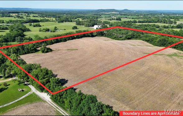 Discover the perfect blend of open space and privacy with this 13.08-acre tract located just off Highway B in Elsberry, Missouri. Featuring 10+/- acres tillable, a gravel entrance, level to sloping terrain, and mature trees surrounding the property, this parcel offers an ideal setting for a custom home, hobby farm, or recreational retreat. The flat, usable acreage provides plenty of room for farming, livestock, gardens, or your dream home. There is a road and utility easement for access. Electricity nearby. No water or sewer. Enjoy peaceful country living with easy access to nearby amenities while taking advantage of the endless possibilities this beautiful acreage has to offer.