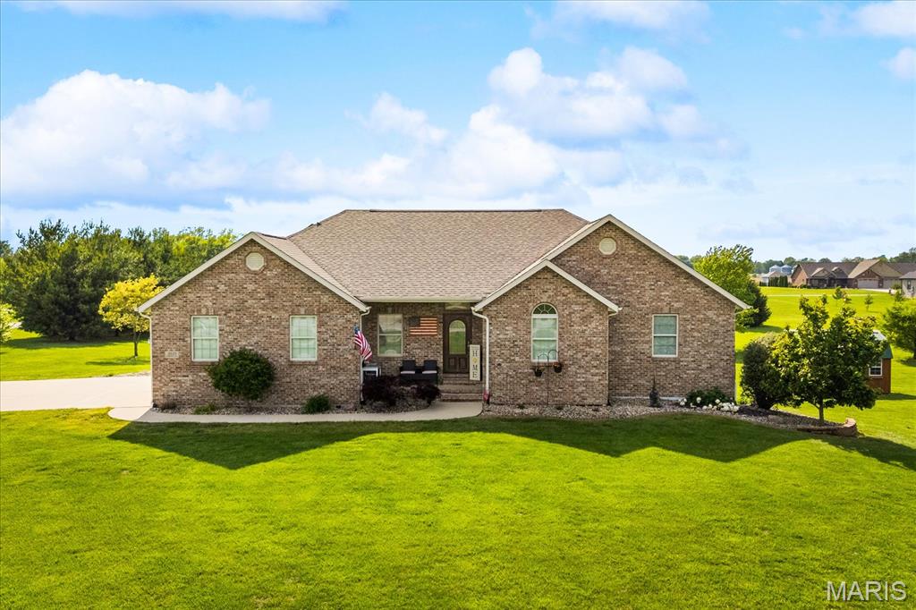 Discover the privacy, space, and versatility of this beautifully maintained ranch-style home situated on 2 peaceful acres in Marine. The inviting open floor plan features vaulted ceilings, abundant natural light, and an easy flow between the living room, dining area, and kitchen. The kitchen offers generous cabinet and counter space, breakfast bar seating, a tile backsplash, and convenient access to the covered deck; an ideal place to enjoy morning coffee, unwind in the evening, or entertain while overlooking the expansive yard. The spacious primary bedroom provides a comfortable retreat, while the walkout lower level adds exceptional flexibility with a large recreation area, second full kitchen, and plenty of room for gatherings, hobbies, guests, or game nights. With multiple living areas and a second kitchen, the lower level also offers excellent potential for multigenerational living, extended-stay guests, or a more private space for adult family members. Outdoor living is equally impressive with a covered deck, patio areas, and a wide-open 2-acre setting offering room to garden, play, entertain, or simply enjoy the quiet surroundings. This is a rare opportunity to own a ranch-style home with a walkout basement, acreage, flexible living space, and a private neighborhood setting. Before making an offer on any property, buyers should independently verify all MLS data derived from various sources and not warrant its accuracy.