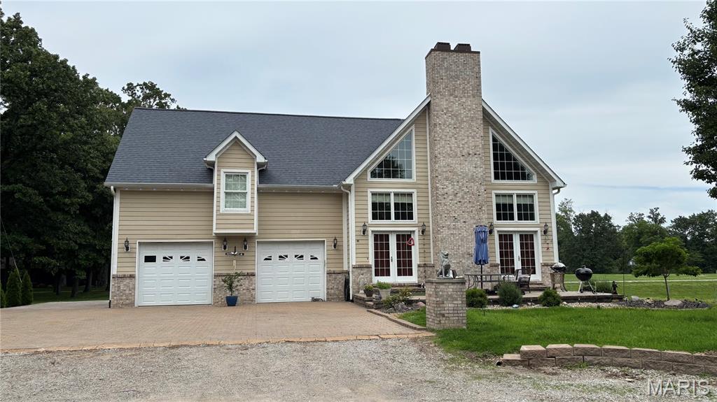 Located at the end of a Cul-De-Sac in beautiful Lake Villa Subdivision; Luxury Living 4 Bedrooms and 2 Baths, with 3rd Basement Bath is plumbed in and ready for you to finish to your own unique ideas.  Over 2,300 square feet of living space, along with a partially finished basement.  Stylish tumble stone paved driveway.  Open concept living area with  beautiful wood vaulted ceilings and wood floors, spacious rooms and closets.  Stone fireplace, Stainless Steel Kitchen Appliances, includes a Smart Refrigerator.  Tankless gas hot water On Demand water heater, Sandstone hard surface kitchen counter tops. A huge upper level Media Room provides a flexible use area for streaming your favorite shows & movies. 2 Car Oversized Garage has heat and A/C.  A Huge back yard includes an extra lot attached.   Just minutes away from the Boulder and Coles Creek Access Areas. Owner is selling AS IS, will make no repairs.
