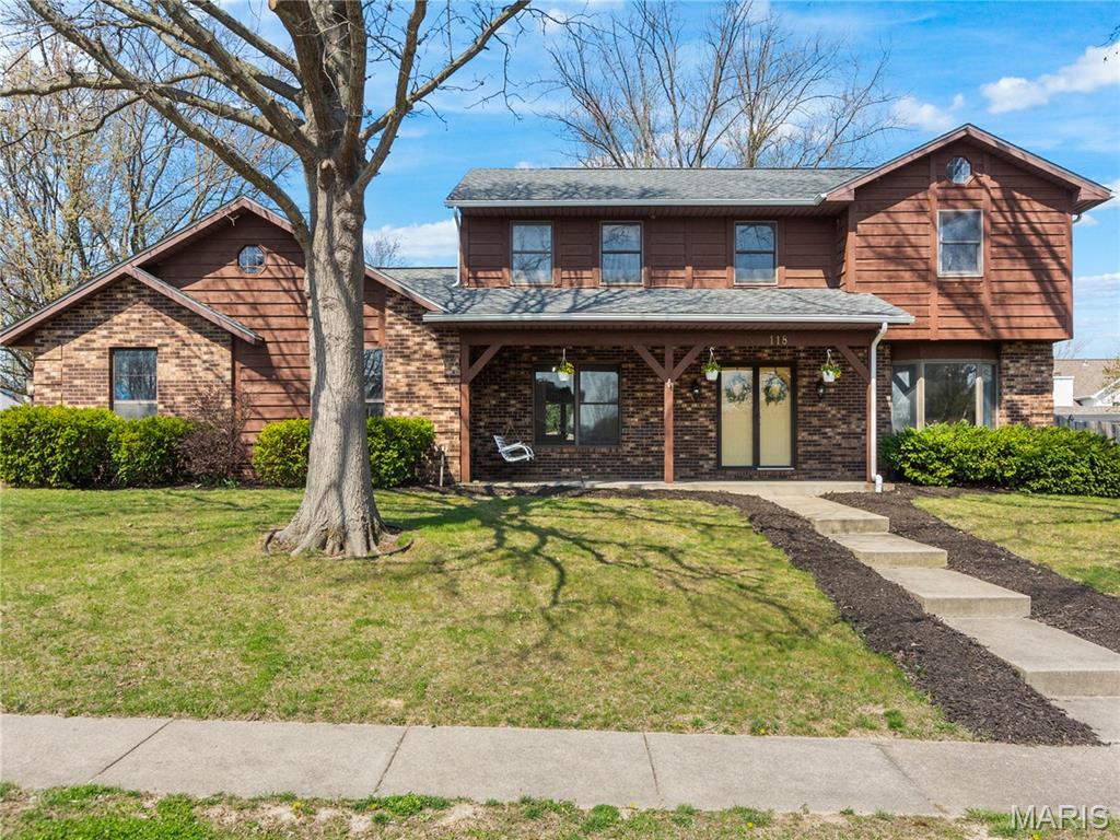 Perfect O'Fallon location! This updated home is over 2,700 square feet, and you'll love the floor plan.  Spacious main level with large formal living room or bonus room, great for flex space, featuring a bay window. You'll love the den for more casual living with a small wet bar, brick wall fireplace, and easy access to the backyard. The kitchen is open, bright, airy, and features granite countertops, stainless steel appliances, 3 pantries, the perfect window for growing herbs, peninsula bartop dining, and a breakfast nook area for casual dining. Additional formal dining area too. Large laundry room has plenty of additional storage, plus utility sink. Upper level has large guest bedrooms, primary bedroom suite with walk-in closet, vaulted ceilings, and updated bathroom flooded with light, stand alone soaking tub, and a separate tiled walk-in shower, plus double vanities. This home sits on a 1/3 of acre corner lot with a side-entry 2-car garage, fenced backyard with large patio, and a fun sand/fire pit area to entertain. Great covered front porch with porch swing for morning coffee and plenty more room to spare. Call your favorite Realtor for a tour!