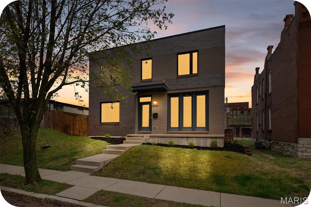 If you are looking for a unique contemporary home in the city, look no more! 4143 Blaine is  simply the dreamiest home in Botanical Heights. Travel down the quiet one-way Blaine Avenue to your modern beauty, built in 2018. Enter into a light-filled space with hardwoods which features your dining room and a flexible area that could be used for an office, art studio, play room and more! A half bathroom with cheery wallpaper is tucked away in a inconspicuous corner for privacy. Notice the artistic detailing of the two story custom built architectural wood and metal staircase which sets the tone for the two show stoppers of this floor: the living room and kitchen. The living room is simply drenched in natural light as a former glass garage door was converted in a wall of windows inviting nature in with a sweeping view of your green space. This transitions seamlessly into the kitchen which features Caeasarstone quartz countertops w/an oversized island & waterfall edge, high end appliances, undercounter built-in microwave, 42 inch soft close cabinets and a pantry that meets all your storage needs! Behind the kitchen, check out the mudroom area and a laundry suite. Upstairs, open the double door entry to your primary suite with two LARGE walk-in closets and a spa-like bathroom featuring a deep soaker tub for all your relaxation needs. All closets upstairs are California custom closets. Around the corner, another full bathroom and two good-sized bedrooms round out the floor. The basement is an unexpected treat with two separate living spaces. The first has a bedroom with a true egress window and an abundance of space for a sitting area or office. Pass the full bathroom (making this floor particularly well suited to a guest suite) to your entertainment area which showcases a kitchenette with a retro refrigerator, sink, and a cinema room. And somehow, these spaces are also very bright and do not remotely feel like a basement. Outside, a DOUBLE lot is rare and perfect for kiddos and fur babies. Don't miss the the pergola with berry bushes growing in the corner as you head to your two car garport with an extra storage shed built in. A wall has been built in front of the cars so that your view is unimpeded from your COVERED patio right outside the back door. If the house itself hasn't swept your off your feet yet, the location is chef's kiss: two blocks from City Garden Montessori School, a few blocks to Union Loafers, La Patisserie Choquette, AO & Co, Indo and other restaurants. It's a short walk to the Botanical Gardens and a slightly longer walk to Tower Grove Park. Easy access to both I-44 and I-64 and it's adjacent to the new Tower Grove bike lane (Tower Grove Connector). This home has also already passed occupancy! The cherry on top: a Tax Abatement through the end of 2028 saving you thousands in taxes. :) Hurry to own this very special home just in time to enjoy the spring in your backyard.
