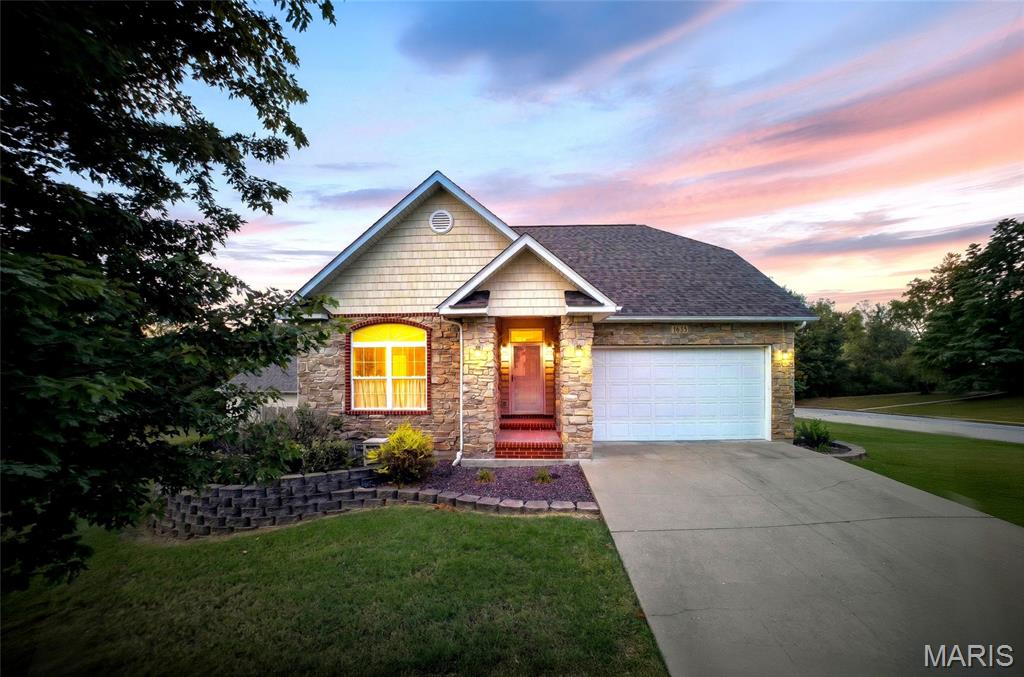 BEAUTIFUL HOME, SPACIOUS LOT AND AN AWESOME SHOP RIGHT ON THE EDGE OF TOWN! This lovely and immaculately maintained 4 bedroom/3.5 bath home was built in 2004.  Situated on a .61 acre double lot on the corner of Yale and Harvard, this home offers both privacy and convenience. Located in the University Park development just minutes from shopping, restaurants, medical services and much more, it is also tucked away on a dead end lane. The beautiful landscaping along with the exterior of brick, stone and vinyl provide a welcoming entrance. Inside, the open foyer leads to the great room with newly refinished maple floors, gas fireplace and dining area and kitchen with ceramic tile. The kitchen has solid surface countertops, stainless steel appliances and a large breakfast bar. Just off the living area is a spacious 19' x 9' partially covered deck that faces the north. Located on the main level, the Primary Suite has the same newly refinished maple floors, vaulted ceiling and private exterior door leading to the covered deck. Glass french doors open from the bedroom to the primary bath which features a double sink vanity, soaker tub, separate shower, water closet and large walk-in closet. Also on the main level is the office. With built-in desk and shelving, luxury vinyl plank floors and large closet, it can easily be used as a bedroom. There is plenty of natural light coming from a double arching window and has a private access to the shared hall bath. Between the office/bedroom and the hall bath is the laundry room and large hall closet. From the entry, an oak staircase leads to the fully finished walkout basement. Offering a second gas fireplace, the spacious family room is a great place for entertaining. Two additional bedrooms are on the lower level along with a full bath and large storage room. The storage room has sturdy shelving and an area with a sink and cabinets which was originally used as a dark room for photography. Slider doors lead from the family room to the concrete patio under the deck complete with porch swing to while away the hours! The side/back entry to the property is located off of Harvard Ave. and leads to the amazing attached 38' x 30' shop. Fully insulated with it's own HVAC, 220 electric, six double windows, side entrance and a 10' automatic overhead door, the shop is open and ready for whatever you need. Complete with a 1/2 bath with double sink and floor drain in the finished concrete floors, the options are limitless here! Outside, the beautiful lawn and extra lot provide plenty of elbow room for everyone. Put in your own pool and use the shop as a pool house! Whatever you can imagine this house has the solution. With a new roof (November, 2025), new HVAC and a pre-list home inspection, you can purchase this property with confidence. Call today for your private showing!