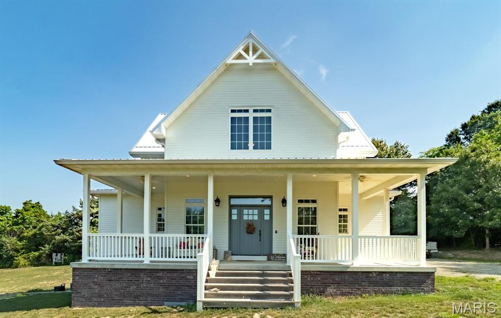 From the winding driveway, the breeze through the covered porches, the huge shop building to the deer and turkey in the front yard, this is heaven in town! This beautiful home is only 9 years old and sits on about 10 acres just inside the city limits. The vaulted ceilings as you walk in are just amazing! The huge kitchen island is where your hang out will be! You will love the custom cabinets w/ soapstone & butcher block countertops! Main floor master bedroom & bath w/ a huge walk-in shower you won't ever want to leave! The spacious loft would be great for your home office! Windows everywhere! The lower level has 2 bedrooms, a full bath, big family room, roomy laundry room and walks out to a big patio.  Just down from the house is a 35X50 shop building w/ storage and a nice studio apartment with a covered porch for extra income or when family comes to visit! High quality construction. Farmhouse style with farmhouse covered porches.  But there's more!  Check out the 4 lots off of Robyn LeeAnn Drive that are included on the attached survey! The lots are included in the 10 acres.  Build some spec homes or just keep for yourself!  So many possibilities!
