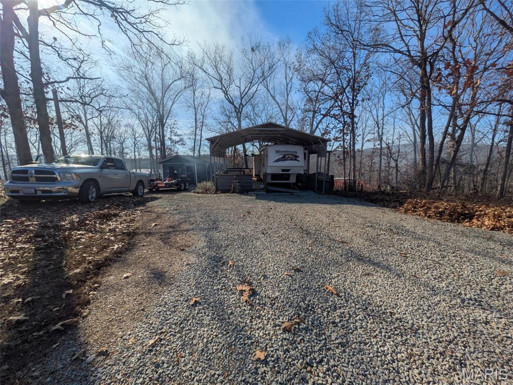 Looking forward to having your own space for outdoor activities or just some quiet time? Welcome to this well-maintained double lot in the gated Goose Creek community. This property is fully set up for immediate use and offers an excellent foundation for a weekend retreat or future lake home.

The property features a 34' camper in excellent condition, offering a king-sized bedroom, full kitchen/living area, real wood flooring, and a built-in vacuum system. The camper is secured on rock and concrete bracing, providing increased stability and longevity.  A large carport covers the camper and provides a 35'x12' seating area with two outdoor, mounted fans.

Additional improvements include a sewage holding tank, a fire pit, a utility shed for storing tools, and a separate laundry room (washer, dryer, and refrigerator included) for added convenience—an uncommon and valuable feature in lake properties.

With two lots, there is ample room for outdoor seating areas, parking, or future building plans. Enjoy all the amenities Goose Creek offers, including gated access, boating, fishing, swimming, and community recreation areas.  There are also electric hook ups for additional campers on the secondary lot should you want to host friends. 

Get ready to enjoy the lake life! Schedule your showing today.

*All persons visiting the property do so at their own risk. Neither seller nor listing brokerage assumes liability for injuries, accidents, or property damage.