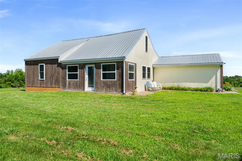 Discover the perfect blend of country charm and modern sustainability on this exceptional 7-acre property in New Haven. This well-maintained 4-bedroom, 3-bath home offers 1,958 square feet of living space, combining the character of its original 1930 farmhouse with thoughtfully designed additions. Inside, you'll find exposed wood-beam ceilings, a striking brick fireplace, and an updated kitchen featuring custom walnut countertops, stainless steel appliances, and abundant natural light from newer triple-pane windows. Outside, you'll find everything needed to embrace peaceful country living—a spring-fed stocked pond, mature apple, pear, peach, cherry and mulberry trees, raised garden beds, a 28' x 48' barn, and a 33' x 30' outbuilding with an additional 1,080 sq. ft. lean-to, offering exceptional space for hobbies, equipment, livestock, or workshop use.
Thoughtfully upgraded with sustainability in mind, this property features a fully owned solar panel system, extensive insulation improvements, triple-pane windows, and a durable metal roof. These investments have helped keep recent electric bills at less than $3 per month while providing year-round comfort and efficiency. Private well and septic, high-speed internet availability, and a peaceful setting complete this truly unique property.