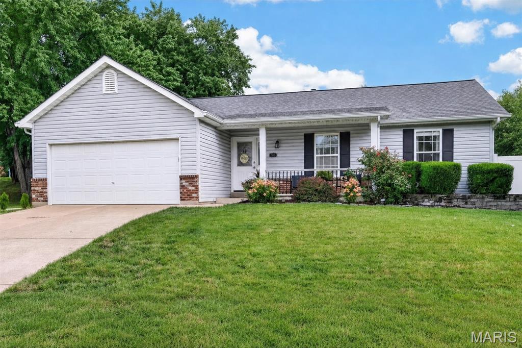 Take the golf cart to dinner in downtown Cottleville, then come home to roughly 2,296 finished square feet on a flat, fenced lot in the Award Winning Francis Howell School District. At $350,000, that combination is hard to find.

The lower level of this Woodland Trails ranch is not a basement. It is a second living space, with a theater room wired for surround sound, a full second kitchen, a full bathroom, a mirrored fitness room, and a private flex room that works just as well as a guest space or a home office. Combined with the open main floor, it brings the home to roughly 2,296 finished square feet, considerably more room than a one level footprint suggests.

A leaded glass front door opens into a proper entry foyer. From there, vaulted ceilings lift the living room, kitchen and breakfast room into a single connected space. A gas fireplace set into a marble tile surround anchors the living area, hardwood floors run throughout the main living spaces, and generous windows keep the entire floor bright. The remodeled kitchen pairs sage cabinetry with granite counters, a stone tile backsplash, under cabinet lighting, a pantry and an island with seating for two. The breakfast room sits in a bay window bump out, with an atrium door that opens directly onto the patio.

The primary bedroom carries the same vaulted ceiling and has its own private bath with an updated vanity. Two additional bedrooms and a second full bath complete the main level, giving the home three full bathrooms in all, one on each level plus the primary suite.

Outside is where this property separates itself. The backyard is flat, fully enclosed in white vinyl privacy fence, and bordered by a stone retaining wall. An extended concrete patio holds two distinct outdoor rooms: a covered gazebo with curtains and string lights, and a dining area sized for a full table. A stone ringed fire pit sits out in the lawn. The yard also has an installed drainage system, which is the difference between a backyard you look at in the spring and one you actually use.

The location is what the current owners mention first. This is a golf cart community, and a short golf cart ride reaches downtown Cottleville for the shops, coffee, restaurants and Piazza Messina. The Cottleville Dardenne Greenway Trail and Legacy Park are both within walking distance, and a small shop just behind the neighborhood sells fresh eggs and coffee. The street is quiet, the lot is level at 0.20 acres, and the home is served by the Francis Howell R-III district.

A few more details worth knowing: an attached two car garage with opener, a coffee bar off the living area, built in bookcases and a desk nook on the lower level, a generous unfinished storage room, a storage shed in the yard, and a newer roof. The refrigerator, oven and microwave stay with the home.

HVAC SYSTEM (2021) NEW ROOF (2026)

Schedule your tour today.