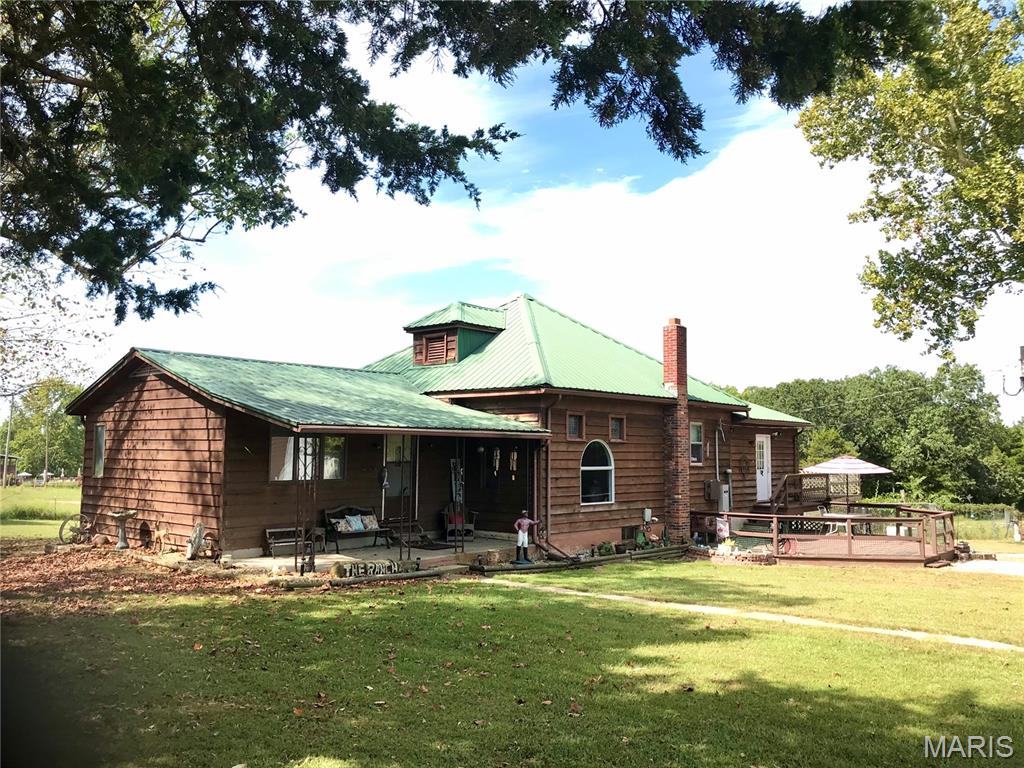 Country Living with Mini-Farm Potential Near Mark Twain National Forest & Meramec River! This cozy and inviting 3-bedroom, 2-bath home offers the perfect blend of country charm, usable acreage, and recreational amenities. Situated on approximately 29 fenced acres, the property features mostly open pasture, a large pond, and plenty of room for livestock, gardening, hobbies, and outdoor enjoyment.

Relax or entertain on the spacious bi-level deck overlooking the back pasture and pond, or gather around the firepit and enjoy the peaceful country setting. The home is filled with character, including stained glass windows, antique light fixtures, and hardwood flooring. Appliances, including the washer and dryer, remain with the property, along with a Generac generator.

The impressive collection of farm and utility improvements includes a 40x60 barn with electric, a 12' overhead door and three 8' doors; metal carport with storage; detached garage with concrete floor and electric; 16x40 loafing shed with lean-to, water and electric; and a fenced chicken house with concrete floor and electric. The fenced acreage offers versatility for a mini farm, hobby farm, livestock, horses, gardening, or recreational use.

Outdoor enthusiasts will appreciate the property's large pond, hunting blinds, shooting range, pasture, and wooded surroundings. Located close to Mark Twain National Forest, the Meramec River for fishing, floating, and recreation, and Maramec Spring Park. Enjoy the convenience of being close to town while still experiencing the privacy and peacefulness of a country setting.

With acreage, pasture, water, multiple outbuildings, utility-equipped structures, recreational features, and a charming home, this property offers a versatile mini-farm and country-living opportunity with plenty of room to spread out and enjoy the outdoors.