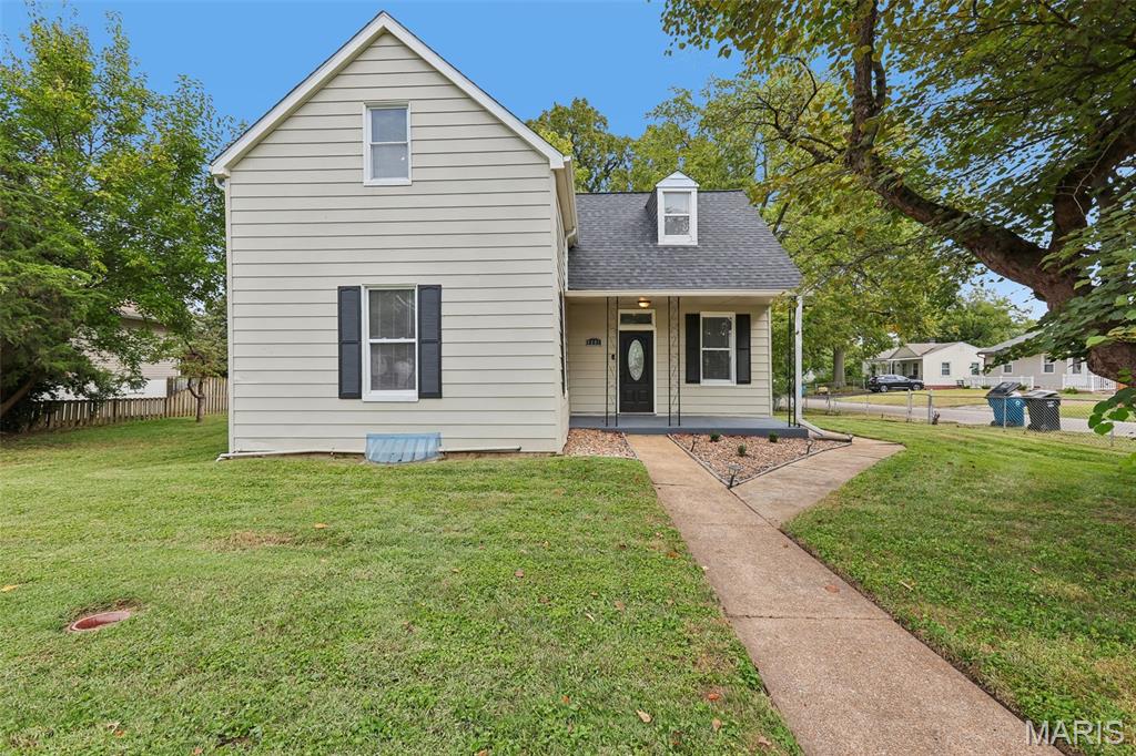 Cottage-style 3-bedroom, 2-full-bath home on a level corner lot in McDermotts Hannover Heights,  Bayless School District. Built in 1901, the home offers 1,120 square feet across two levels with a stone foundation, vinyl siding exterior that was painted in 2024, and a new architectural shingle roof installed in 2025. Main-level living includes a foyer with an oval-glass front door and hardwood floors. A main-floor bedroom with dark wood-panel accent walls and a ceiling fan, and a full bath. The kitchen features shaker style dark cabinetry, granite countertops, stainless steel appliances, a movable prep island, and an exposed brick accent wall. Upstairs, two bedrooms share a full bath, both with vaulted ceilings and ceiling fans; one bedroom includes beadboard ceiling detail. The upstairs is completed by a loft area finished with a whitewashed shiplap accent wall leading down the stairs. The partial basement houses the laundry area, a sump pit and pump, a dehumidifier, a radon mitigation system, and a new electric water heater 2025. Outdoors, the wood deck off the rear of the home steps down to a fenced backyard with two storage sheds, a fire pit, and a concrete patio pad — ready for outdoor entertaining. The corner lot totals .256 acres (11,160 sq ft). The Home sits approx. 0.8 mi (3 min) to Kendricks Deli, approx. 1.0 mi (5 min) to Schnucks, and approx. 3.3 mi (8 min) to the River Des Peres Greenway for walking and biking. Access to I-55 at the Bayless Avenue exit is approx. 1 mi away.