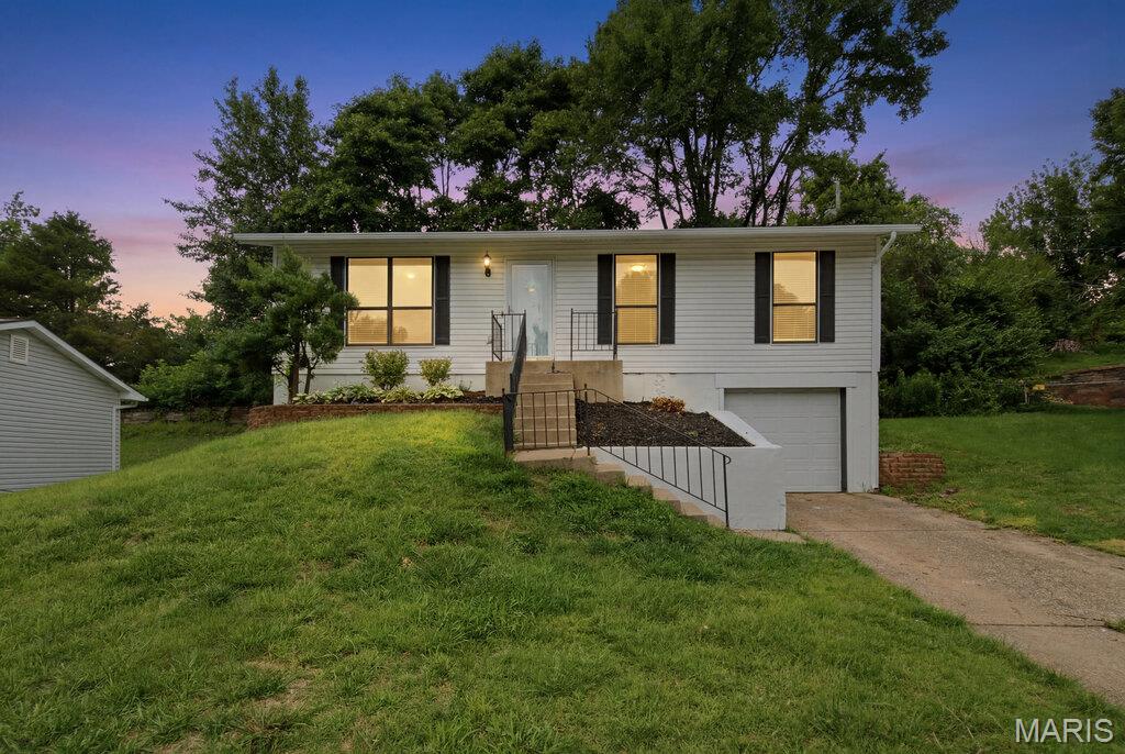 Welcome home to this gorgeous raised ranch tucked away on a quiet cul-de-sac! Thoughtfully updated and truly move-in ready, this charming home features an open-concept floor plan with stylish luxury vinyl plank flooring throughout, creating a seamless and modern feel. The trendy kitchen offers great workspace, updated finishes, and a rustic backsplash that adds warmth and character. Fresh paint throughout gives the entire home a bright, clean, and inviting atmosphere. The beautifully updated bathrooms provide a fresh, contemporary touch, while the spacious living areas offer plenty of room for everyday living and entertaining. Step outside to enjoy the excellent backyard space, complete with a brand-new concrete patio—perfect for hosting friends and family, grilling out, or simply relaxing outdoors. Additional highlights include an attached one-car garage, extra off-street parking, and a highly desirable location close to schools, shopping, restaurants, and everyday conveniences. A rare find that combines modern updates, functional living space, and a fantastic setting—this area gem is one you won't want to miss!