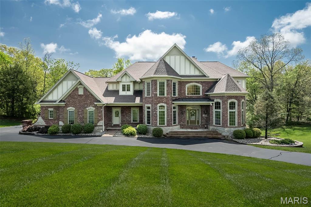 Experience luxury living at its finest in this stunning custom-built 1.5-story home, perfectly situated on 3 private, wooded acres offering ultimate peace and privacy. Boasting over 5,700 square feet of impeccably finished living space, this exceptional property showcases superior craftsmanship, thoughtful design, & timeless elegance. Step inside to an open, light-filled floor plan featuring soaring ceilings, rich hardwood flooring, custom millwork, and designer finishes throughout. The spacious main-floor primary suite provides a true retreat w/ a spa-like bath & expansive walk-in closets. Entertain effortlessly in the gourmet kitchen, hearth & formal dining room, & impressive great room w/ gas fireplace. Upstairs, find generously sized bedrooms, a versatile loft, & abundant storage. The walkout lower level is a showstopper, complete with a recreation area, fitness space & a half bath. Enjoy year-round outdoor living surrounded by breathtaking wooded views. A truly rare opportunity!