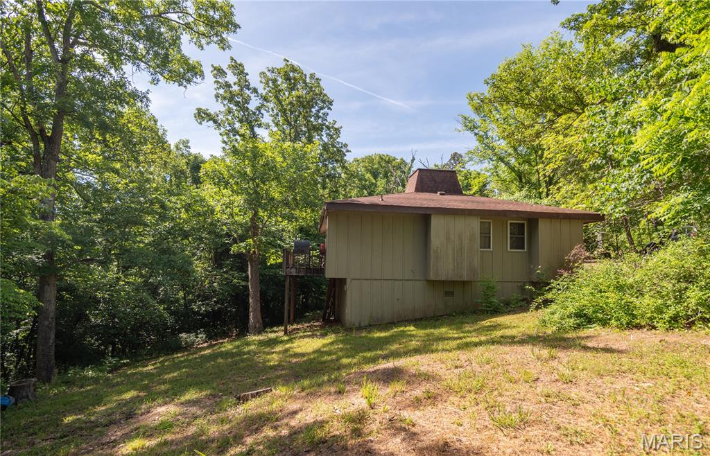 Vintage charm meets river living in this 3 bedroom, 1 bath cabin located in the highly desirable Deer Run subdivision. Situated on two lots, this cozy retreat features a vaulted ceiling, warm wood-burning fireplace, and plenty of rustic character throughout. Whether you're looking for a weekend getaway or a full-time residence, this property offers endless possibilities. Enjoy exclusive access to the private beach and boat launch, making it easy to spend your days on the water and your evenings relaxing by the fire. A rare opportunity to own a charming cabin in one of the area's most sought-after lake communities.