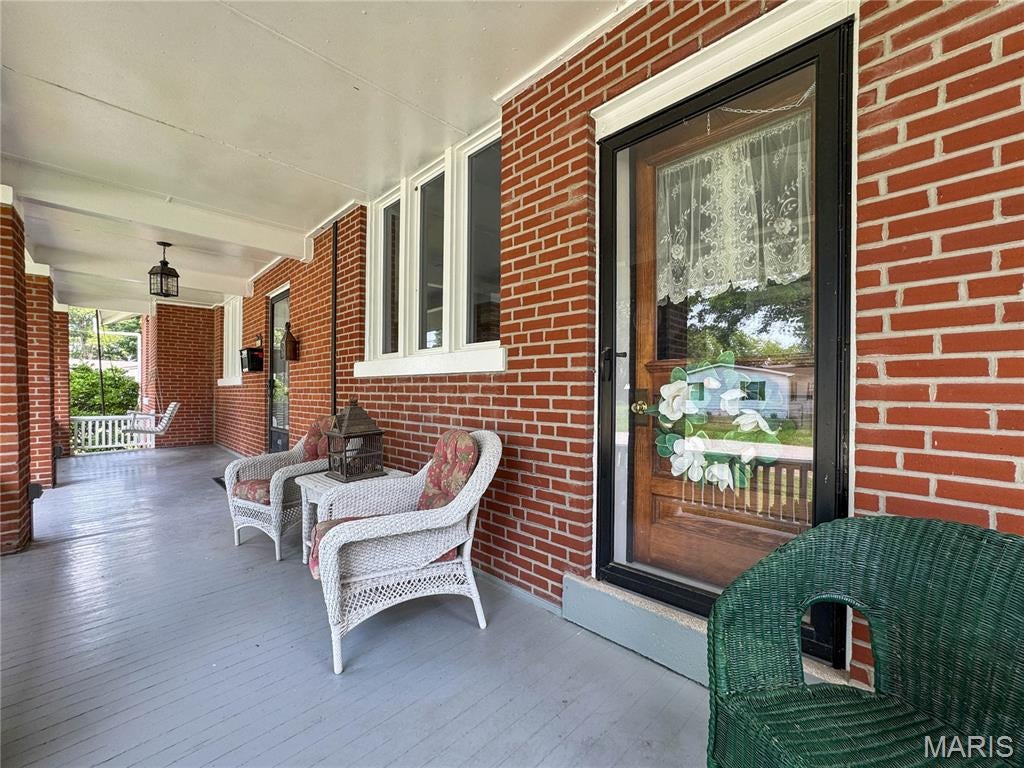 Charming all-brick 1911 historic home in remarkable condition, lovingly maintained by the same owner for over 60 years. Vintage touches throughout add warmth and nostalgia, while major updates provide comfort and efficiency. With over 2,500 sq. ft. of finished living space—not including the immaculate, bright, dry, and freshly painted lower-level storage rooms—this home offers an exceptional blend of character and practicality. Radiant heat and central air keep utility costs manageable year-round.

Situated on three beautifully landscaped lots totaling .60 acres, the property features lush perennial beds, concrete curbing, and multiple driveways. Three outbuildings, each with its own unique features—including one heated and insulated—provide abundant space for hobbies, storage, or a private studio. 

The all-brick exterior is complemented by a full front porch with fresh paint and a classic porch swing, perfect for friendly, neighborly evenings. The expansive backyard offers plenty of room for play, gardening, or entertaining.

Inside, 9' ceilings enhance the spacious feel. The open living and dining area is a massive, centrally located gathering space. Off the living room, a cozy study/library/den features a full wall of built-ins and an inviting nook ideal for an electric fireplace.

The large eat-in kitchen includes 42" solid wood cabinetry, Corian countertops, and generous storage, plus a convenient butler’s pantry connecting to the dining room. Two main-floor bedrooms offer flexibility—one with a walk-in closet, the other with a private enclosed porch overlooking the backyard, perfect for a gym, reading nook, or quiet retreat. A vintage main-floor bath in pristine condition adds timeless charm. Two laundry chutes between the main and upper levels add everyday convenience.

Upstairs, a huge landing provides the perfect space for study time, gaming, slumber parties, or creative fun. A built-in desk with mirror and outlet is ideal for homework or makeup practice. Two very large bedrooms flank the landing, each with storage and built-in bookcases. Ceiling heights upstairs range from 6.5' to 7'. A central half bath and a quiet nook between rooms create additional functional spaces for studying or sensory needs.

The lower level is truly exceptional—one of the nicest basements you’ll find in a home of this age. Bright, dry, painted, and meticulously maintained, every room offers something useful. A full bath with walk-in shower is perfect for muddy days or direct entry from the storm-door entrance. Storage, workshop space, and spotless utility areas round out this impressive level.

This home oozes charm, character, and positive energy—a rare opportunity to own a historic property in extraordinary condition with unmatched space, updates, and personality. New Athens location close to river recreation and public landg delivers more for your money.