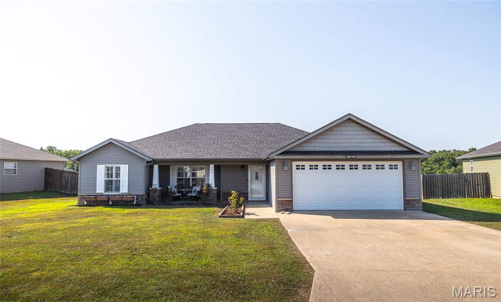 Welcome home to this beautifully maintained 3-bedroom, 2-bath home in the highly sought-after Brush Creek Subdivision in St. Robert, MO, where comfort, style, and convenience come together. Ideally located just minutes from Fort Leonard Wood's main gate, as well as shopping, dining, and everyday conveniences, this home offers the perfect blend of peaceful neighborhood living and easy access to everything you need.

Step onto the inviting covered front porch and into a bright, open living space featuring soaring vaulted ceilings that create an airy, welcoming atmosphere. Luxury vinyl plank flooring flows throughout the main living areas and bedrooms, while durable tile flooring in the kitchen and bathrooms adds both style and practicality. The thoughtfully designed layout makes everyday living and entertaining effortless.

The spacious primary suite provides a relaxing retreat with an elegant tray ceiling, a private ensuite bath featuring a dual vanity, and a walk-in shower. Two additional bedrooms offer flexibility for family, guests, or a home office.

Outside, you'll love the flat backyard with a patio that's perfect for grilling, entertaining, or simply unwinding after a long day. Whether you're enjoying quiet evenings at home or hosting friends and family, this outdoor space is ready for every occasion.

If you're searching for a move-in ready home in St. Robert with modern finishes, a desirable location, and easy access to Fort Leonard Wood, this one deserves a spot at the top of your list. Schedule your private showing today and discover everything this Brush Creek beauty has to offer!