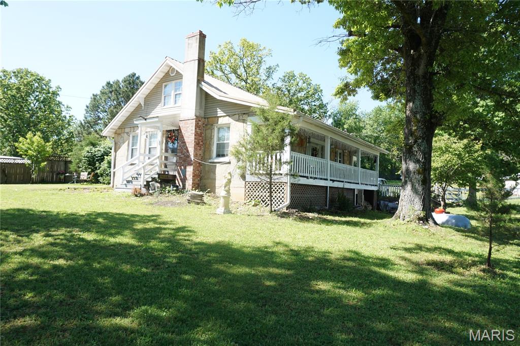 This adorable stone home offers the perfect blend of charm and convenience! Sitting on 1.5 acres on a corner lot, it features public water PLUS a private well, septic, and a durable metal roof.

Enjoy a cozy wood stove in the living room, with space ready for an additional wood stove in the finished walk-out basement. The home also includes a 2-car detached garage and plenty of room to spread out—while still being close to town and local stores.