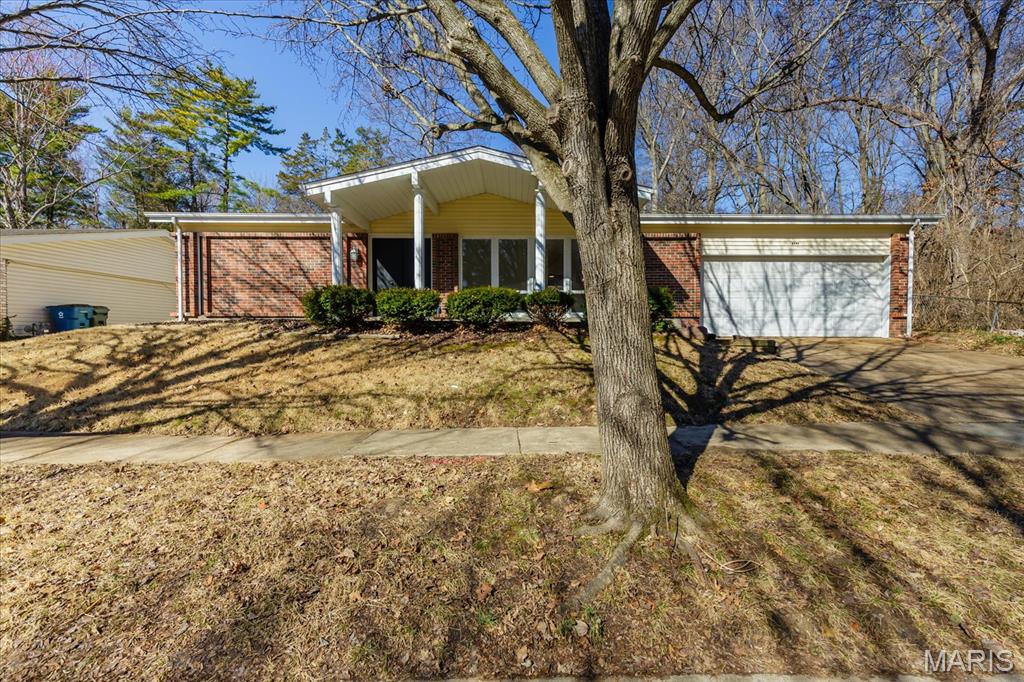 Welcome to this stunning, fully renovated 3-bedroom, 2-bathroom ranch that perfectly blends modern style with functional living. Every inch of this home has been upgraded to provide a move-in-ready experience for its next owner. The amazing kitchen is completely new, featuring sleek white shaker cabinets, elegant quartz countertops, and a full suite of stainless steel appliances, including a brand-new refrigerator. You will love the new luxury vinyl plank (LVP) flooring that flows throughout the entire home. The aesthetic is tied together with new lighting, contemporary black fixtures, and matching black door knobs and hinges. Enjoy a bright, spacious living and dining room combo, plus a separate sitting room featuring a cozy wood-burning fireplace—ideal for relaxing evenings. Both bathrooms are entirely new from top to bottom, reflecting the home’s consistent modern design. This home is built on a slab, offering easy, no-step living without the maintenance of a basement. While there is no lower level, storage is never an issue! The attached 2-car garage includes a rare extra extension, providing ample space for a boat, a substantial workshop, or all your seasonal storage needs. Rest easy under a brand-new roof. Located at the end of a quiet dead-end street, this property backs to woods for maximum privacy. The exterior also features a covered porch and a fenced yard with a patio, perfect for outdoor entertaining.