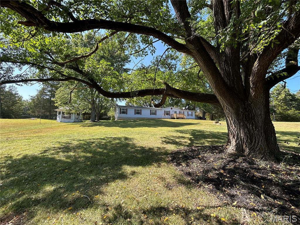 Nestled on approximately 4 beautiful acres in the Desoto countryside, this well-maintained and updated 3-bedroom, 2-bath home offers the perfect blend of peaceful country living and everyday comfort. From the moment you arrive, you'll be welcomed by mature shade trees, wide open views, and a private setting that feels like home.

Inside, you'll find over 2,000sq. ft. of living space featuring new flooring throughout, a cozy stone fireplace, spacious living areas, walk-in closets, a large soaking tub, and convenient main floor laundry. The open layout and abundance of windows bring in natural light and beautiful views of the surrounding property.

Step outside to enjoy brand-new front and back decks, with the back deck featuring a built-in doggy ramp for pets. The detached 2-car garage/carport, charming gazebo, wishing well, garden area, and open usable acreage make this property truly special. Wildlife is often seen throughout the property, creating a peaceful outdoor setting perfect for relaxing, gardening, entertaining, or simply enjoying the outdoors.

Whether you're searching for a private retreat, mini homestead potential, or room to spread out and enjoy country living, this move in ready property offers it all!