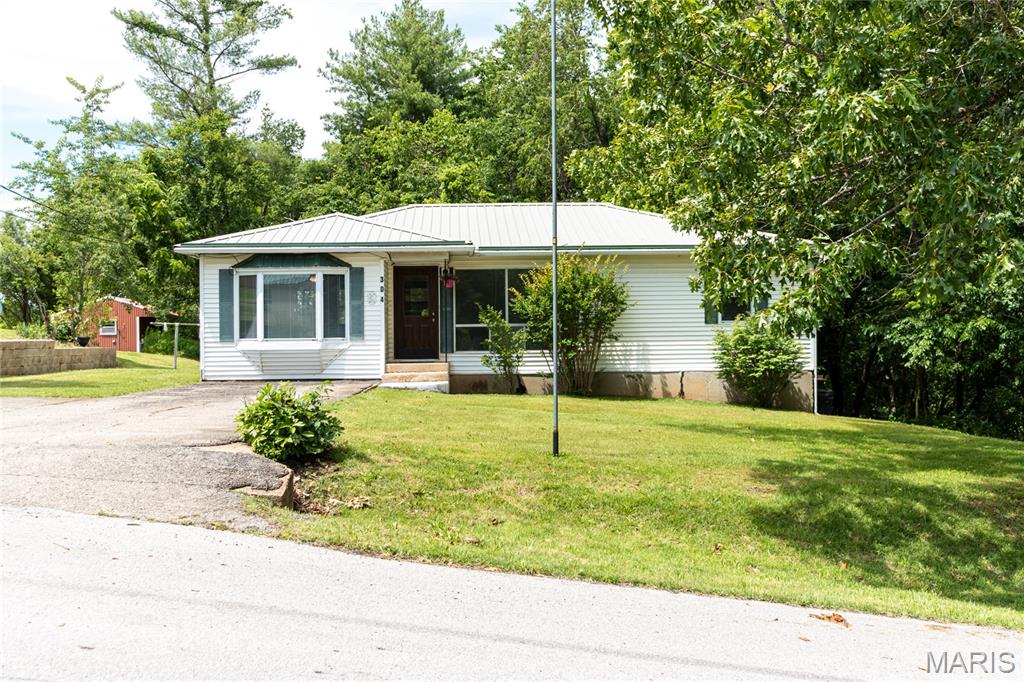 Welcome home to this charming and well-maintained property ideally located directly across from Dixon Elementary School and next to the city park. Situated on a spacious lot with mature trees and plenty of room to enjoy the outdoors, this home offers the perfect blend of comfort, functionality, and future potential.

Inside, you'll find two generous living spaces, with plush newer carpet, giving everyone room to spread out and enjoy. The bright bay window fills the main living area with natural light, creating a warm and inviting atmosphere. The additional family room offers flexibility for entertaining, relaxing, or even creating a formal dining space for holiday gatherings and special occasions.

The walkout basement adds even more possibilities, featuring a bonus room that could serve as a home office, hobby room, guest space, or potential fourth bedroom. Recent plumbing updates provide peace of mind and make the basement an ideal candidate for the addition of a future bathroom.

Outside, the expansive yard offers endless opportunities for gardening, play, or outdoor entertaining. An existing storage shed provides additional storage, while two large concrete pads are ready for a future greenhouse, workshop, fire pit area, or additional outbuilding. The extra driveway leading to the walkout basement adds convenience and functionality rarely found in homes at this price point. This house also comes with a brand-new HVAC system, and a recently replaced dishwasher and clothes dryer!

Whether you're looking for room to grow, space to entertain, or a home with flexibility for years to come, this property is full of opportunity. Schedule your private showing today and see all it has to offer!