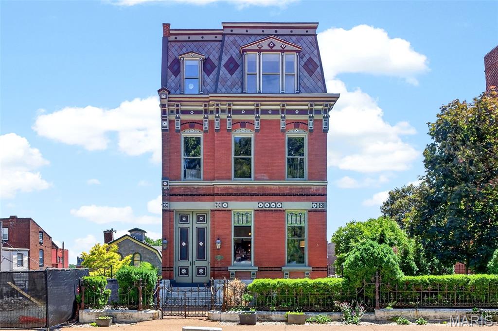 Presenting a once-in-a-generation opportunity to own one of Soulard’s most extraordinary historic estates. The Henry Nicolaus House, built in 1885 for brewery superintendent Henry Nicolaus, this grand second empire mansion sits along what neighbors once called "Beer Barons Row" - a stretch once connecting some of Saint Louis' most prominent brewing families. This historic masterpiece has been meticulously restored and reimagined with uncompromising luxury at every turn. Behind the fully restored French inspired facade, complete with iconic mansard rooflines, hand milled exterior accent flourishes, and timeless gas lanterns, lies over 7,700 square feet of exquisitely finished living space designed to rival the finest luxury homes in the country.

Meticulously and thoughtfully renovated over several years, this architectural showpiece seamlessly blends irreplaceable historic character with cutting edge modern living. Original hardwood floors, soaring 12 foot ceilings, elegant recessed lighting, and richly appointed living spaces create an atmosphere of sophistication and warmth throughout. The chef’s kitchen is a true centerpiece, featuring professional grade JennAir appliances, Brazilian marble countertops, 48" range with double ovens, custom finishes, and exceptional entertaining space.

Although it lives beautifully as one grand single family residence, the home is organized into three highly functional sections, creating exceptional flexibility. Each section includes its own kitchen, laundry, bathrooms, and private living potential ideal for extended stay guests, multi-generational living, private guest spaces, luxury short term rental use, or large scale entertaining.  

The primary suite is a private sanctuary, offering a spa inspired Carrara marble bathroom, smart Kohler Anthem shower system with multiple rain heads, freestanding Kohler soaking tub, expansive custom walk-in closet, and private laundry. Additional bathrooms continue with similar elevated finishes and refined designer details.

Beyond its beauty, the home has been intelligently modernized for comfort, efficiency, and piece of mind. Features include four newer HVAC systems, whole home smart automation with voice command functionality, solar panels, smart electrical panel with backup battery, tankless water heater, whole-house water filtration system, and three TPO roofs replaced in 2024 with 40 year warranty.

A rare grotto style sub-basement wine cellar adds another layer of distinction, while the panoramic rooftop terrace delivers breathtaking skyline views stretching across Downtown St. Louis, the Anheuser-Busch Brewery, and the Mississippi River. Whether hosting intimate gatherings or large-scale entertaining, the rooftop experience is simply unforgettable.

Set on two city fenced lots, the property includes two separate two car garages, a private two car parking pad, and Level 2 EV charging station- an extraordinary amenity package rarely found in the city. Offering the scale, flexibility, and infrastructure to function as an exceptional single family estate or a potential luxury multi-family investment, this landmark home represents a blend of historic elegance, modern innovation, and enduring architectural significance in the heart of historic Soulard-a feat nearly impossible to replicate.