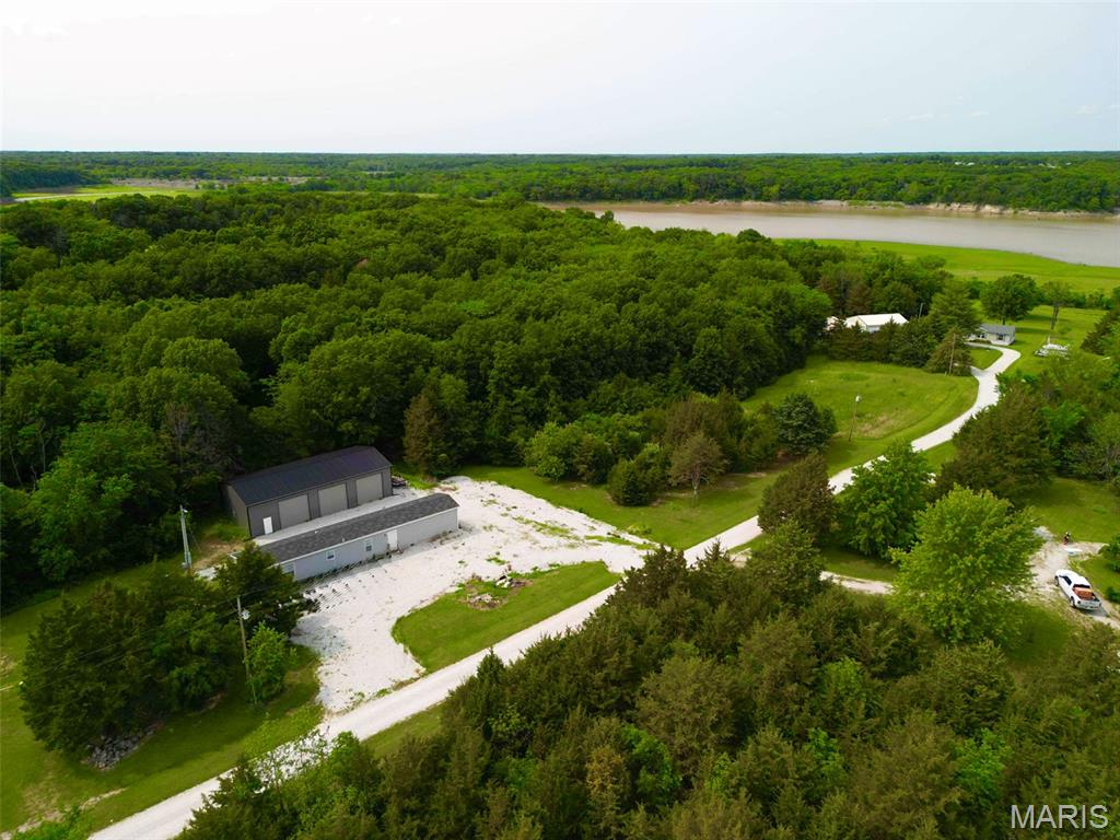OPEN HOUSE, Sunday August 9th, 12pm-2pm.  Whether you're searching for the ultimate Mark Twain Lake weekend getaway or a comfortable full-time residence, this 3.4+/- acre property offers the space, storage, and convenience you've been looking for! Built in 2023, the spacious manufactured home features an inviting open-concept floor plan that's perfect for gathering with family and friends after a day on the lake. The oversized primary suite offers a large bedroom and a private ensuite bath, creating a relaxing retreat at the end of the day.
The true showstopper is the incredible 30' x 60' oversized garage, designed with lake enthusiasts in mind. Featuring 14-foot sidewalls, three 12' x 10' overhead doors across the front, a 9' x 8' rear overhead door, and a 10' x 30' loft with a 5-foot kickout, there's room for boats, campers, UTVs, vehicles, workshop space, and all of your lake toys.
Ideally located just 10 minutes from two public boat ramps and only 15 minutes from Paris, Missouri, you'll enjoy quick access to some of the best boating, fishing, and recreation Mark Twain Lake has to offer while still having the privacy of acreage to call your own. Whether you're looking for a low-maintenance lake retreat, an investment property, or your forever home, this one checks all the boxes. Don't miss your opportunity to own a property that combines modern living, unmatched storage, and the Mark Twain Lake lifestyle!