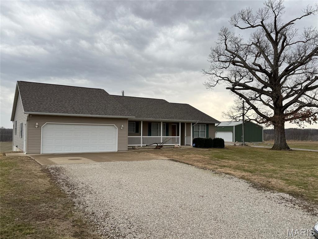 What a view !!!! Walk in the front door, with the living room, which has  cathedral ceiling  and  a double sided gas log fireplace and french door and windows looking out to a view across the bottom land. Or walk out onto the deck with trek decking.. The kitchen dining area has a nice open floor plan. The kitchen has a nice walk in pantry. This home has 3 bedrooms 3 bath. One of the bedrooms is being used as a laundry room. The Primary bedroom has a nice walk in closet, plus a nice large closet. All the bedrooms have nice closets. The Primary bath has a walk in jetted tub, and a shower. This home has 6 panels doors and whole house central vac.  Walk downstairs to french doors, that lead outside. Ceilings are 9'. The basement does have a full bathroom, and the rest is all open to a design how you want to arrange.  Step outside and you have a smoke house, that would be a cute playhouse with a covered patio. And what every man wants to put his toys in, 2 large sheds  one 30' X 40' with concrete floor, and one 60' X 80'.  After a long hot day enjoy the stocked pond for swimming, fishing or sit under the pavilion and just enjoy the day. There is a small  shed to keep your swimming and fishing gear, and also a outhouse.  Roof Oct 2025, Furnace & Air 2019, propane tank stay, Home has Fayette Water and the property has 2 wells. SW Electric  Appliances are aprox 4-5 yrs old. Make your appt to see your dream home !!!