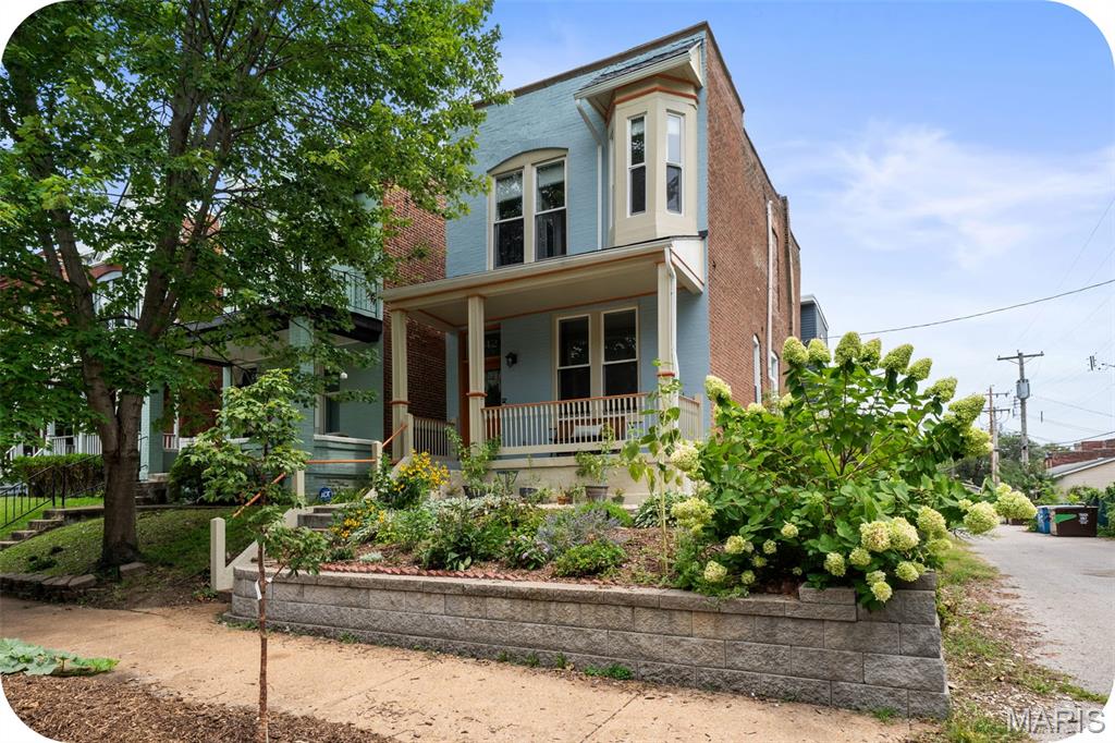 Nestled in the heart of Fox Park, this beautifully renovated 3-bedroom, 2.5-bath home seamlessly blends timeless historic character with thoughtful modern design. Built in 1890, the home welcomes you with a charming front porch--the perfect spot to enjoy your morning coffee. Step inside to discover a bright, open and airy floor plan filled with natural light. An exposed-brick fireplace surround serves as a striking focal point in the living room, which flows effortlessly into the dining room. The thoughtfully designed kitchen is a chef's dream featuring a generous island, granite countertops, stainless steel appliances, and an abundance of custom cabinetry. Just off the kitchen, an additional room offers the flexibility to serve as a cozy breakfast room, home office, or creative space. A convenient half bath rounds out the main level. Upstairs, the serene primary suite offers a spacious walk-in closet and a luxurious en-suite bath with dual vanities. Two additional  bedrooms, a second full bath, and a convenient laundry closet complete the second floor. The appeal continues outdoors with a wonderful patio and pergola, creating an inviting setting for al fresco dining, entertaining, or relaxing with family and friends. The fully fenced yard also features a 2-car garage port equipped with an electric car charger -- just one of the many thoughtful upgrades added by the current owners. As well as being meticulously maintained, additional improvements include a new mini-split system for added comfort in the third bedroom, a new second floor furnace, new sump pump, and new ProVia energy-efficient exterior doors, among other updates. All of this in a fantastic Fox Park location, within walking distance of neighborhood parks and beloved local restaurants including Little Fox, Lona's Lil Eats and so much more. Historic charm, modern updates, thoughtful outdoor spaces, and an unbeatable location --just move in and enjoy!